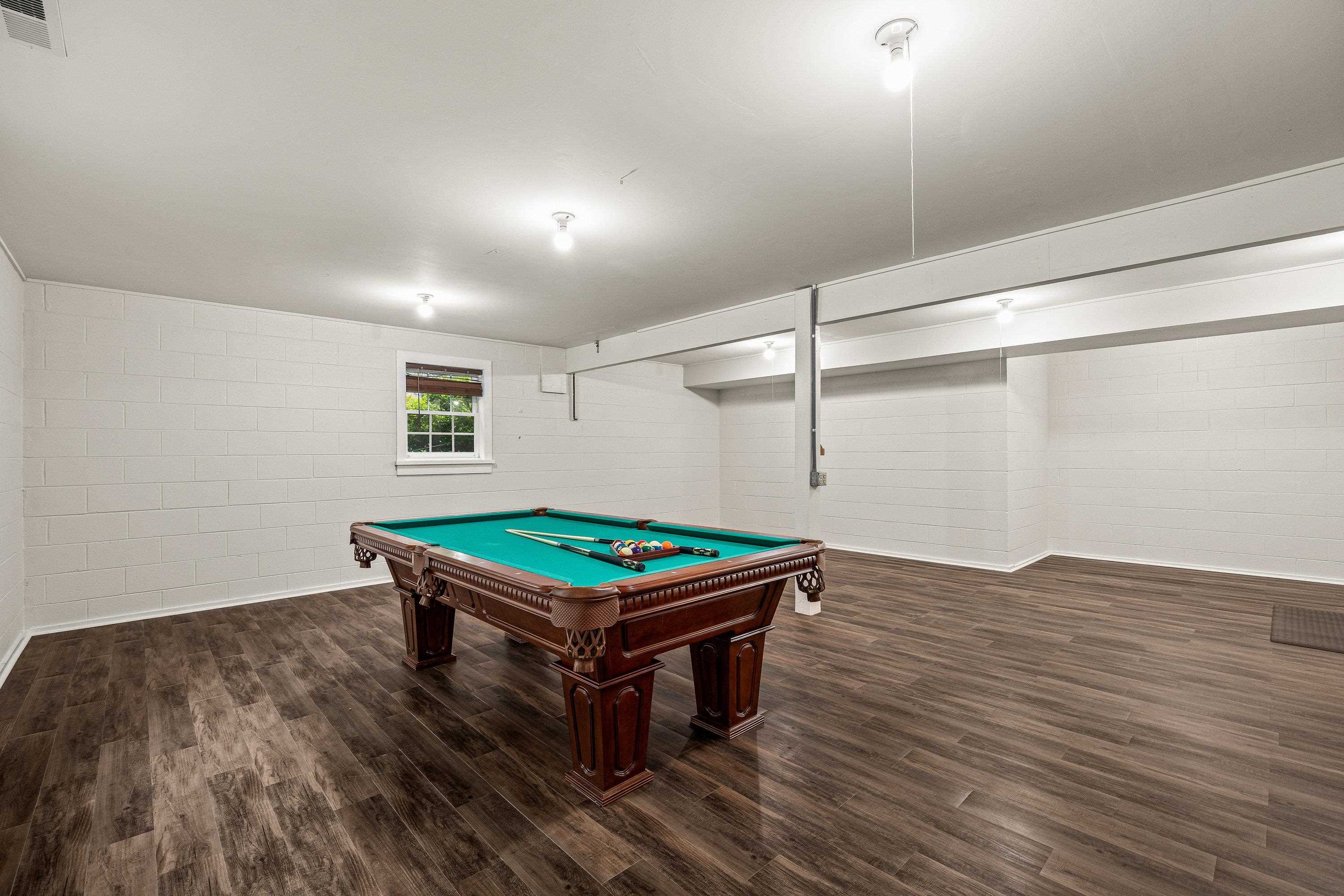 A billiard table in an added bonus in this very large game room.  This space offers luxury vinyl plank flooring, recessed lighting, and much more!
