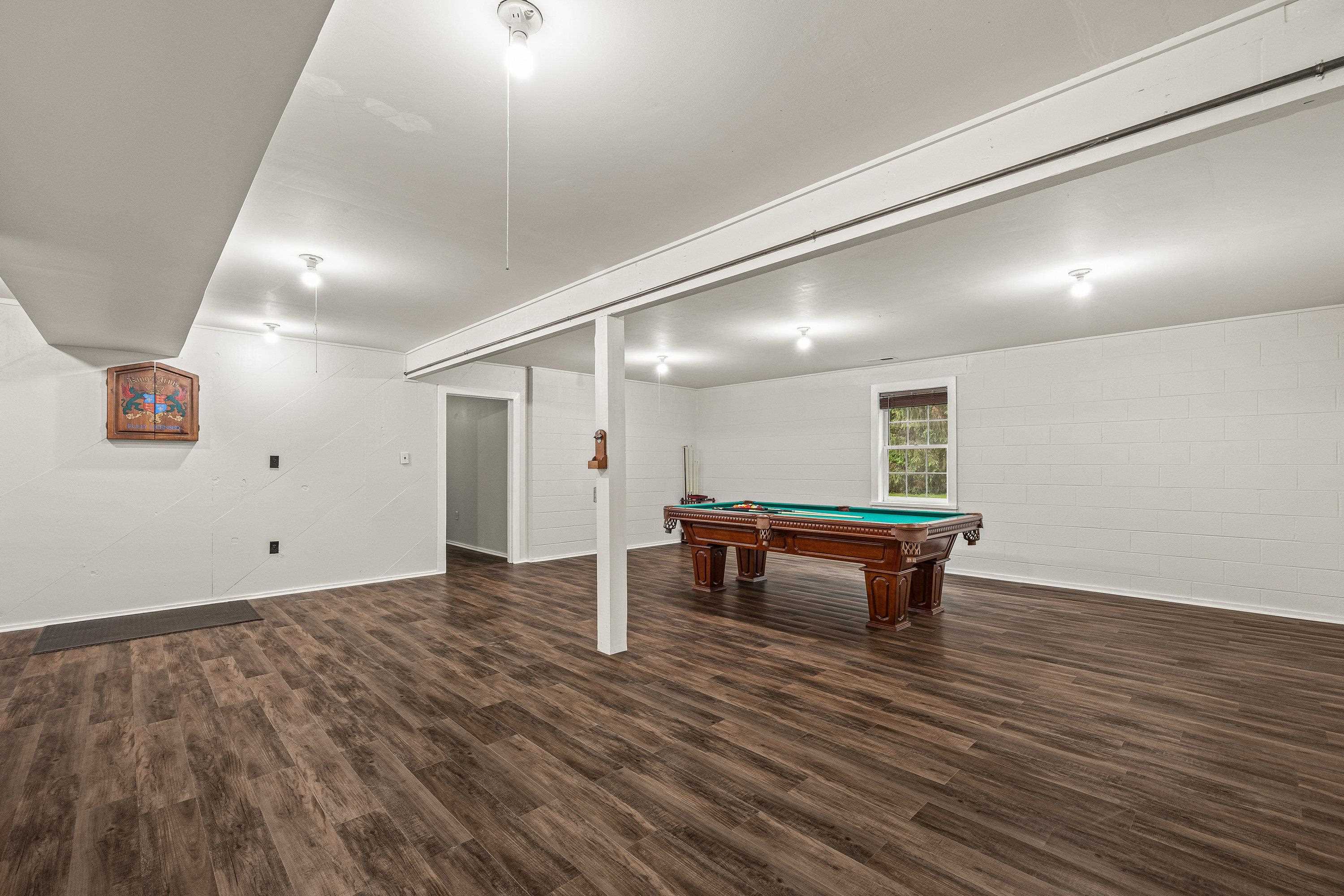 A billiard table in an added bonus in this very large game room.  This space offers luxury vinyl plank flooring, recessed lighting, and much more!