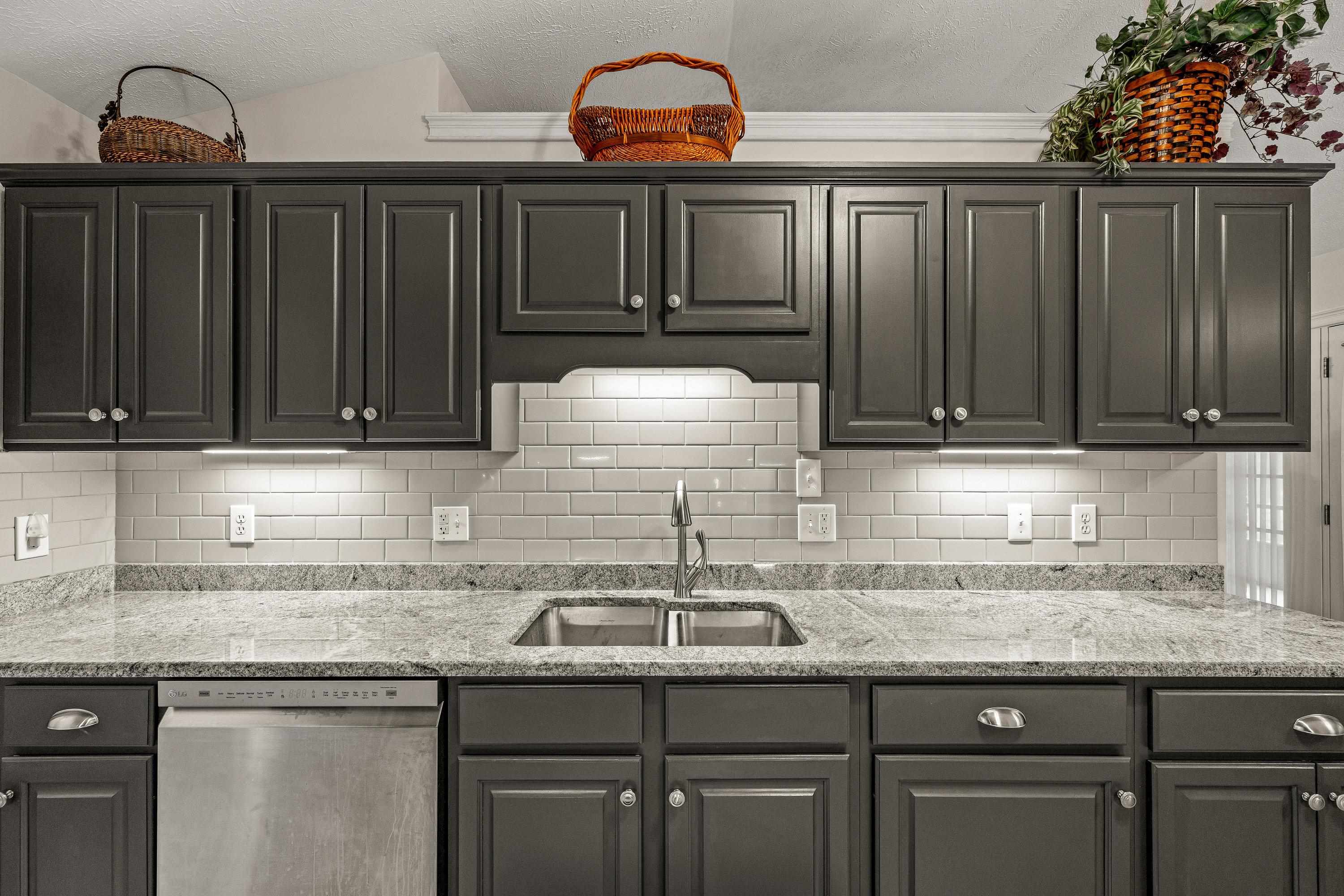 The updated kitchen contains new cabinetry, granite counter-tops, ceramic tile flooring, under cabinet lighting, and stainless steel appliances!