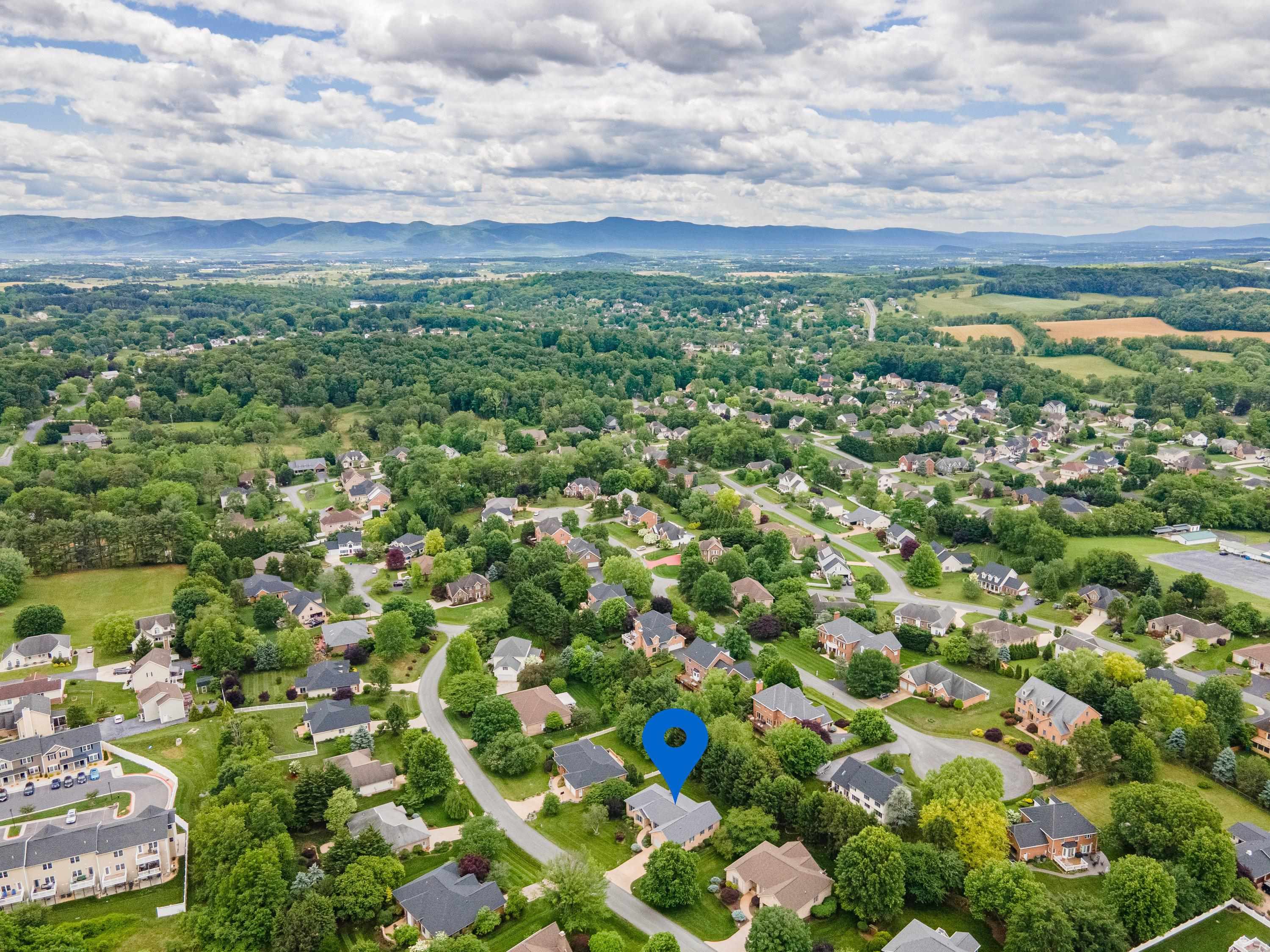 The aerial view highlights the spacious lot this home is located on, the mature landscaping surrounding the home, and the Barrington subdivision.