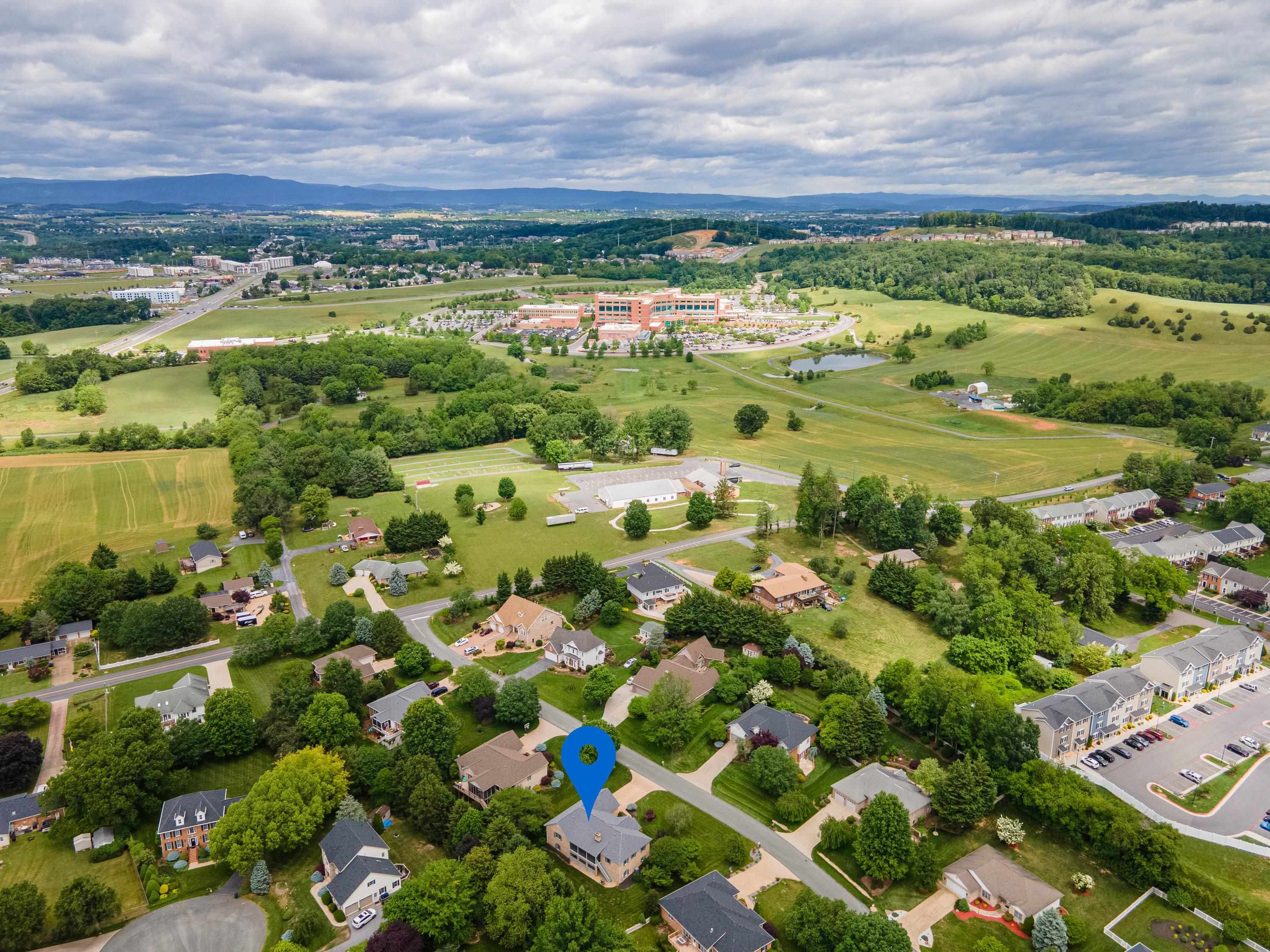 The aerial view highlights the spacious lot this home is located on, the mature landscaping surrounding the home, and the Barrington subdivision.