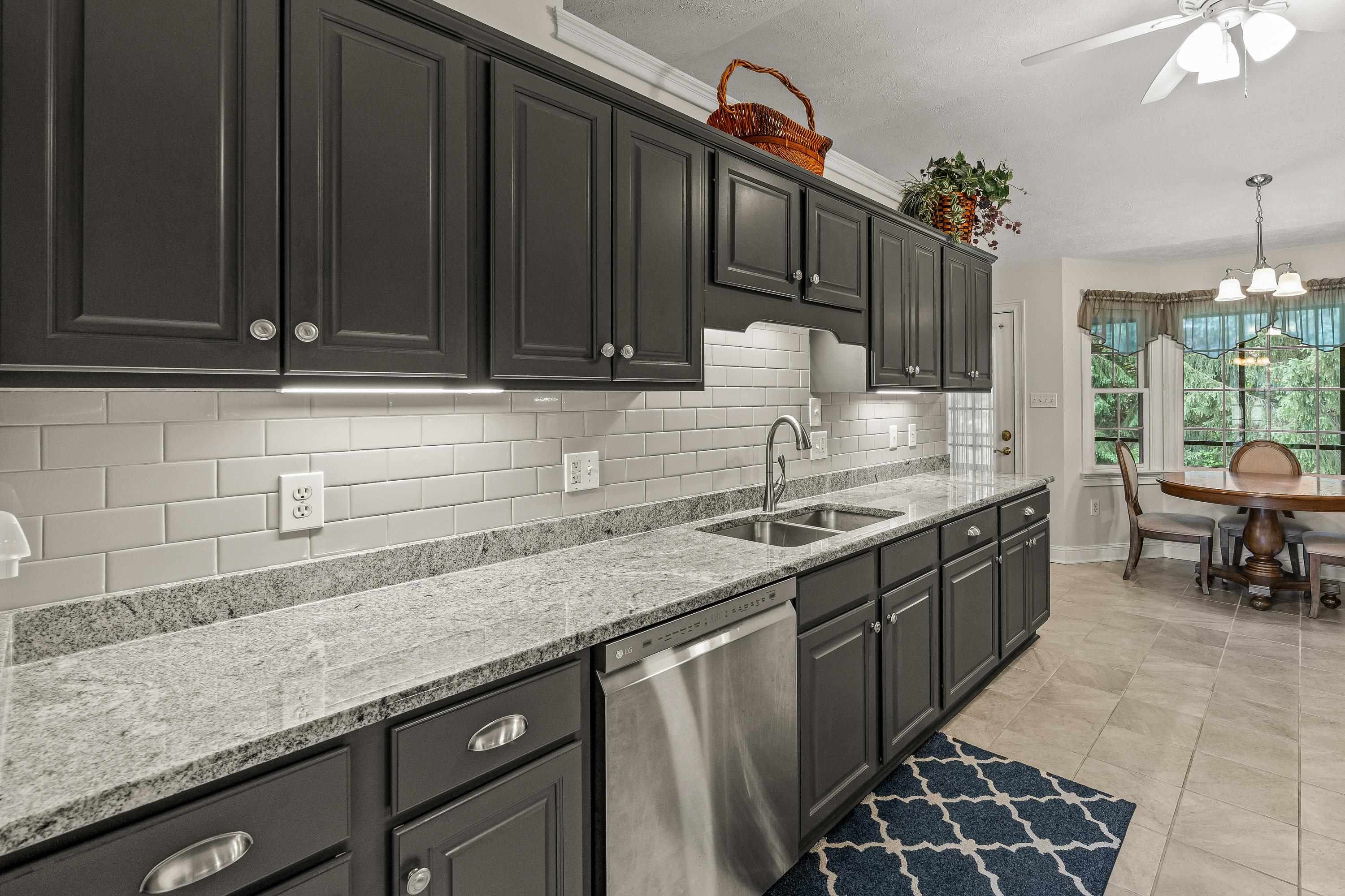 The updated kitchen contains new cabinetry, granite counter-tops, ceramic tile flooring, under cabinet lighting, and stainless steel appliances!