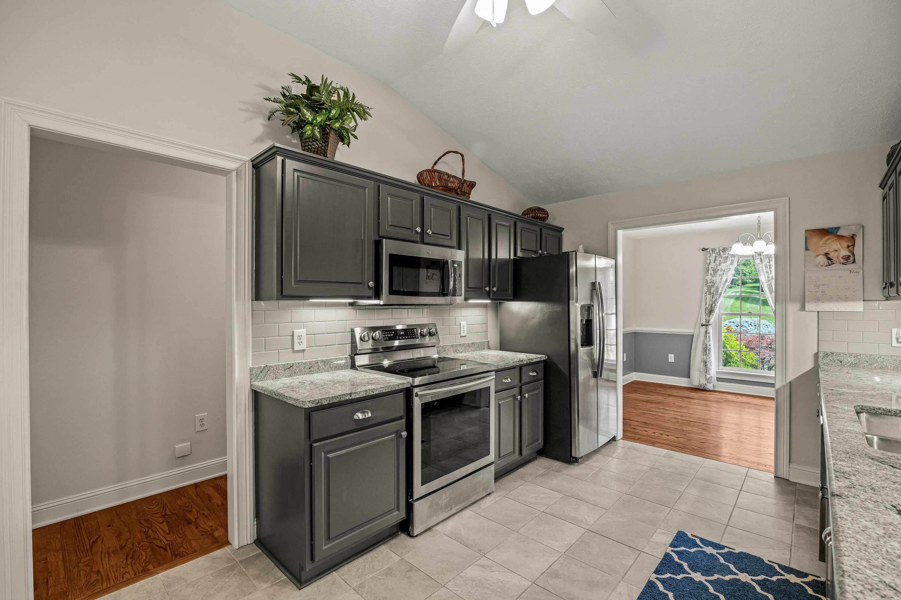 The updated kitchen contains new cabinetry, granite counter-tops, ceramic tile flooring, under cabinet lighting, and stainless steel appliances!