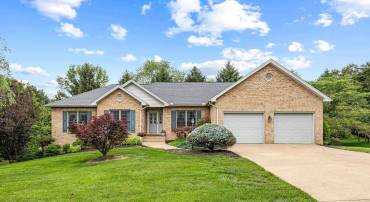 The front view of the beautiful home located at 2875 Barrington Drive in the lovely and established neighborhood of Barrington Estates.  The front view highlights the brick exterior of the home, two car garage, and mature landscaping surrounding the home!