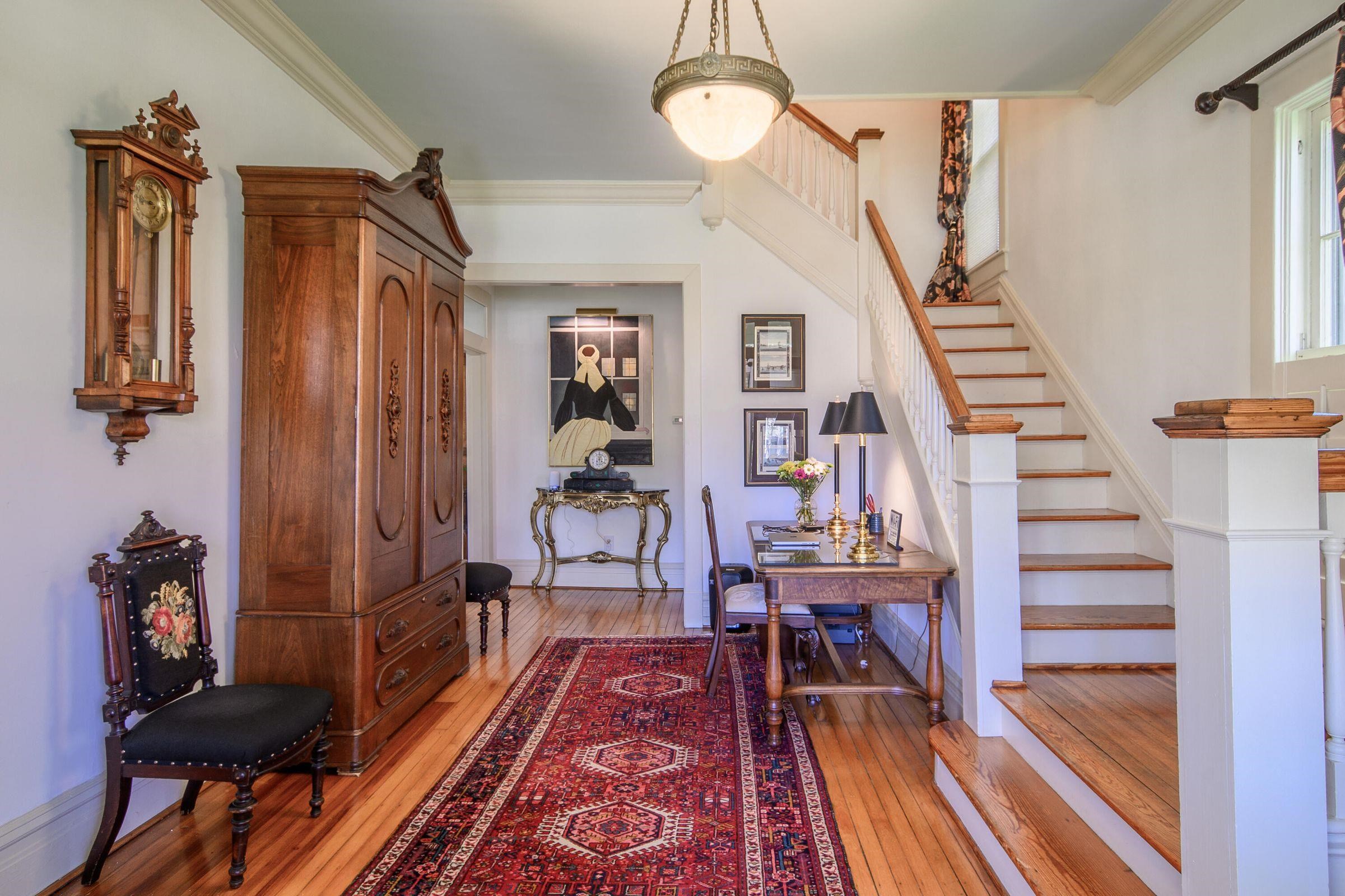 Enter into the spacious foyer. 10 foot ceilings, crown molding, antique lighting.