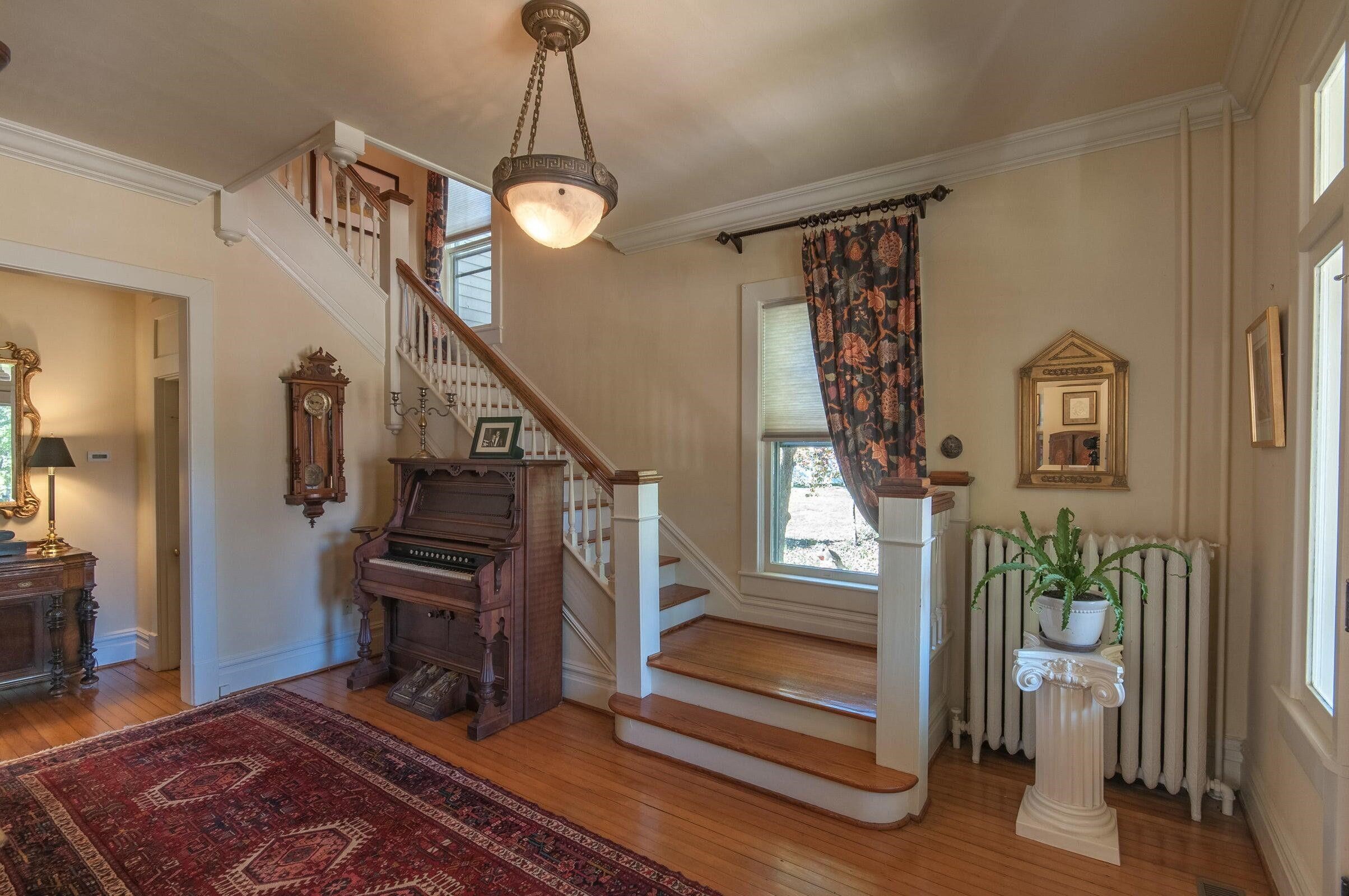 The foyer boasts original wood floors of butter nut and heart of pine. Stairs lead to second floor.