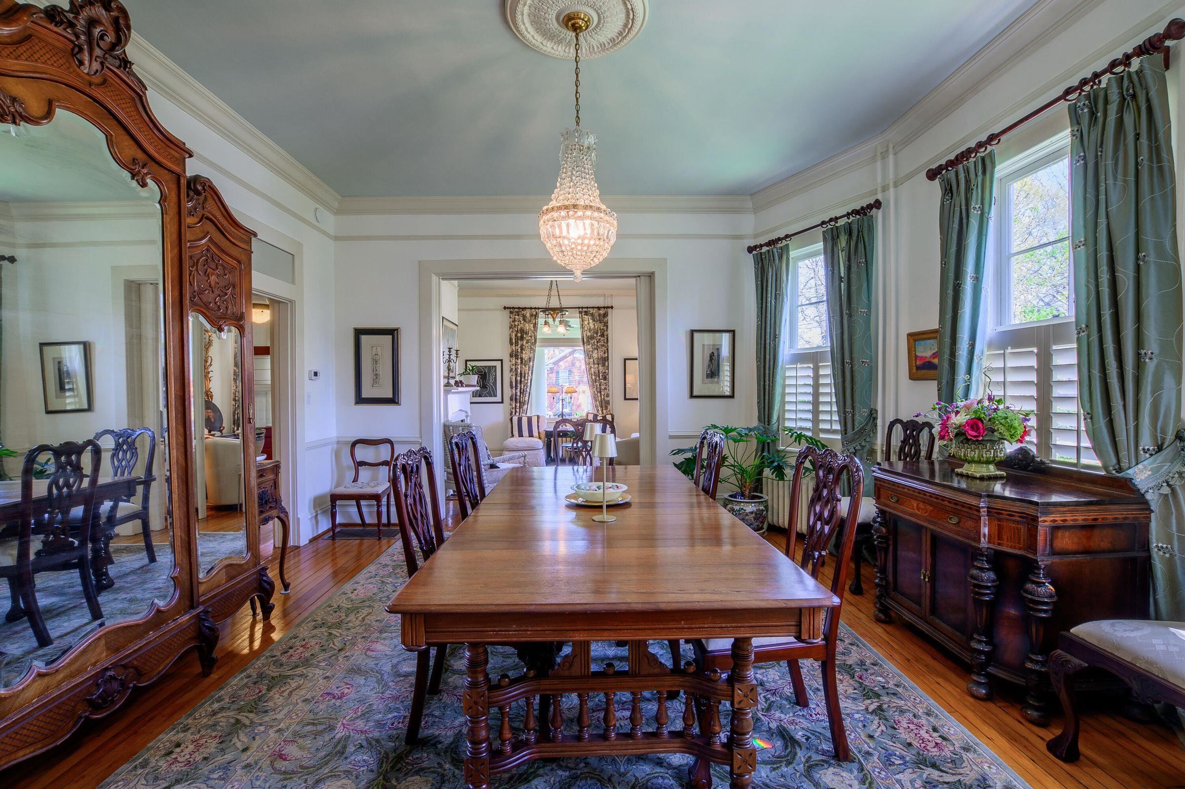 Bowed windows featuring the original glass panes, bring light into the dining room.