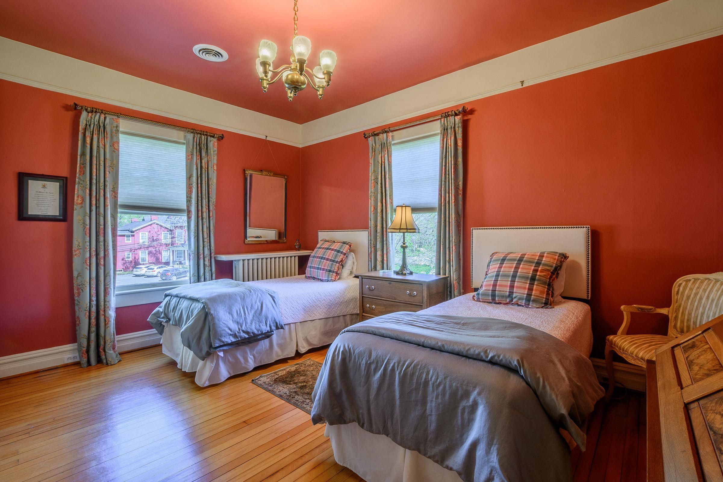 Bedroom #2, vibrant, with crown molding.