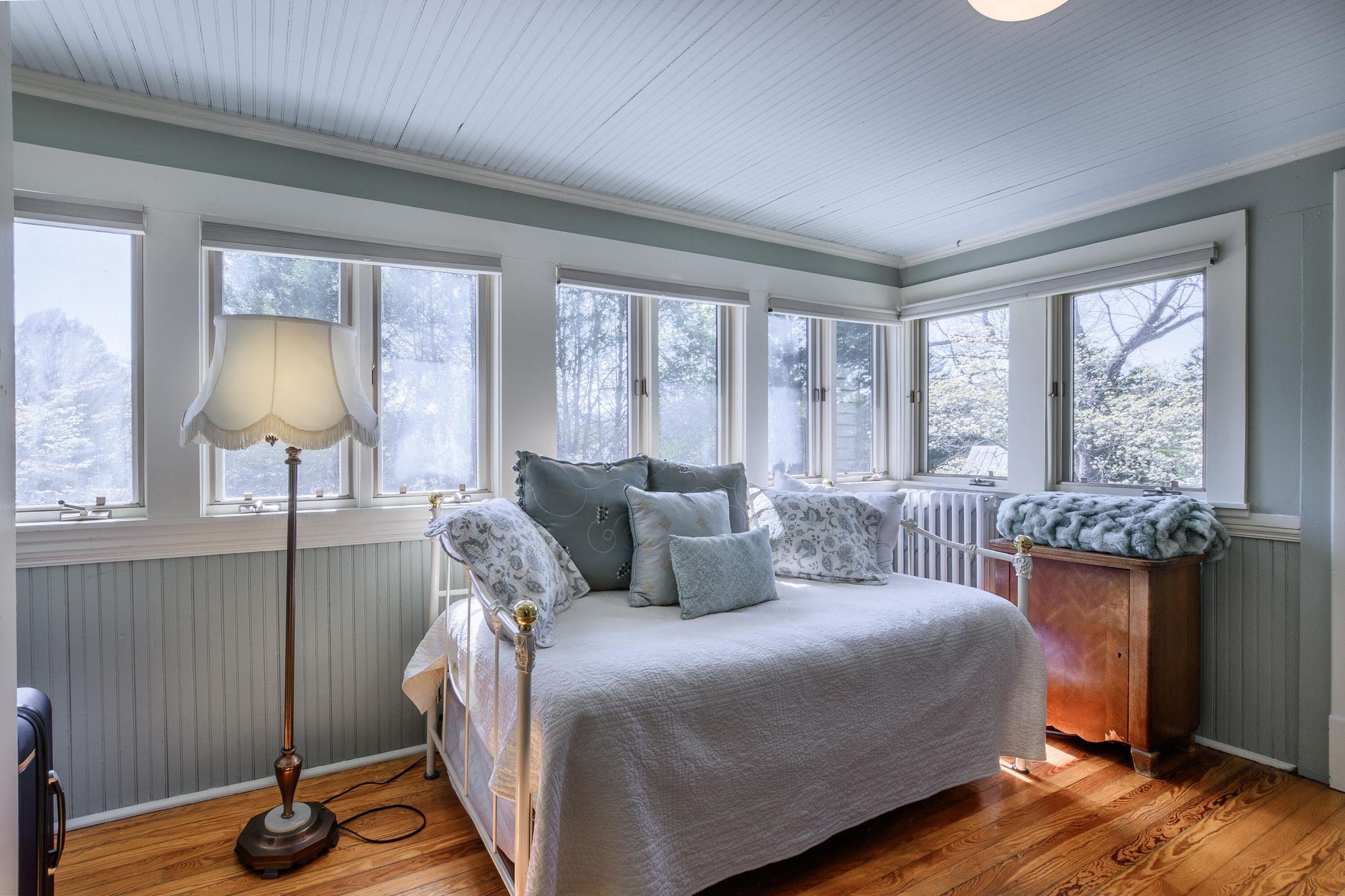 Enclosed 2nd story porch offers multiple possible uses: office/study, 6th bedroom, play room, light-filled studio.