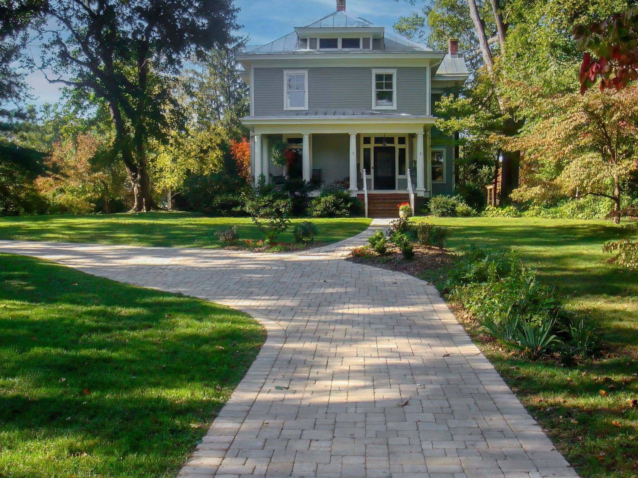 Lovely circular driveway with block pavers.