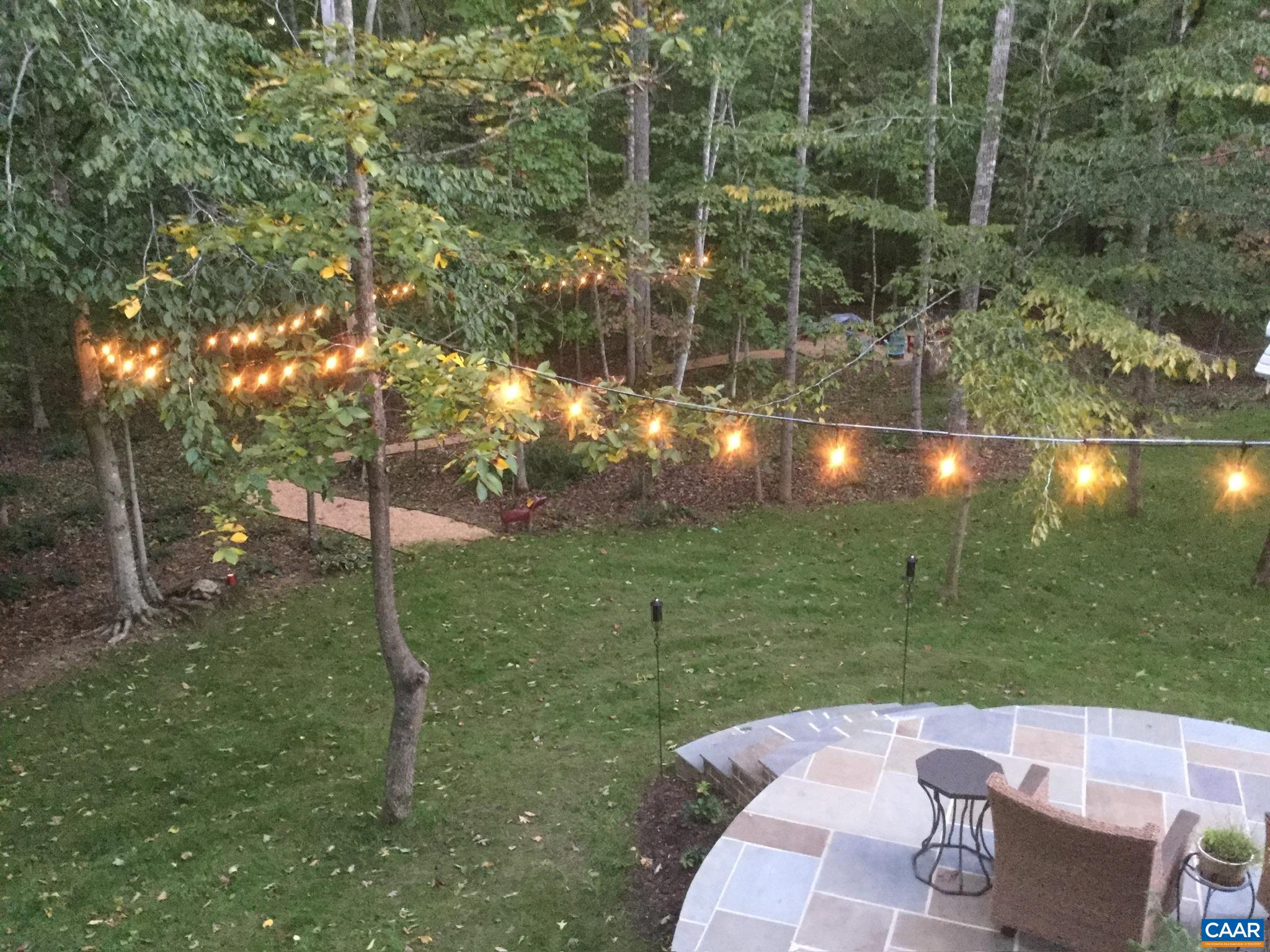 View from the deck over the patio and out to the fire pit.