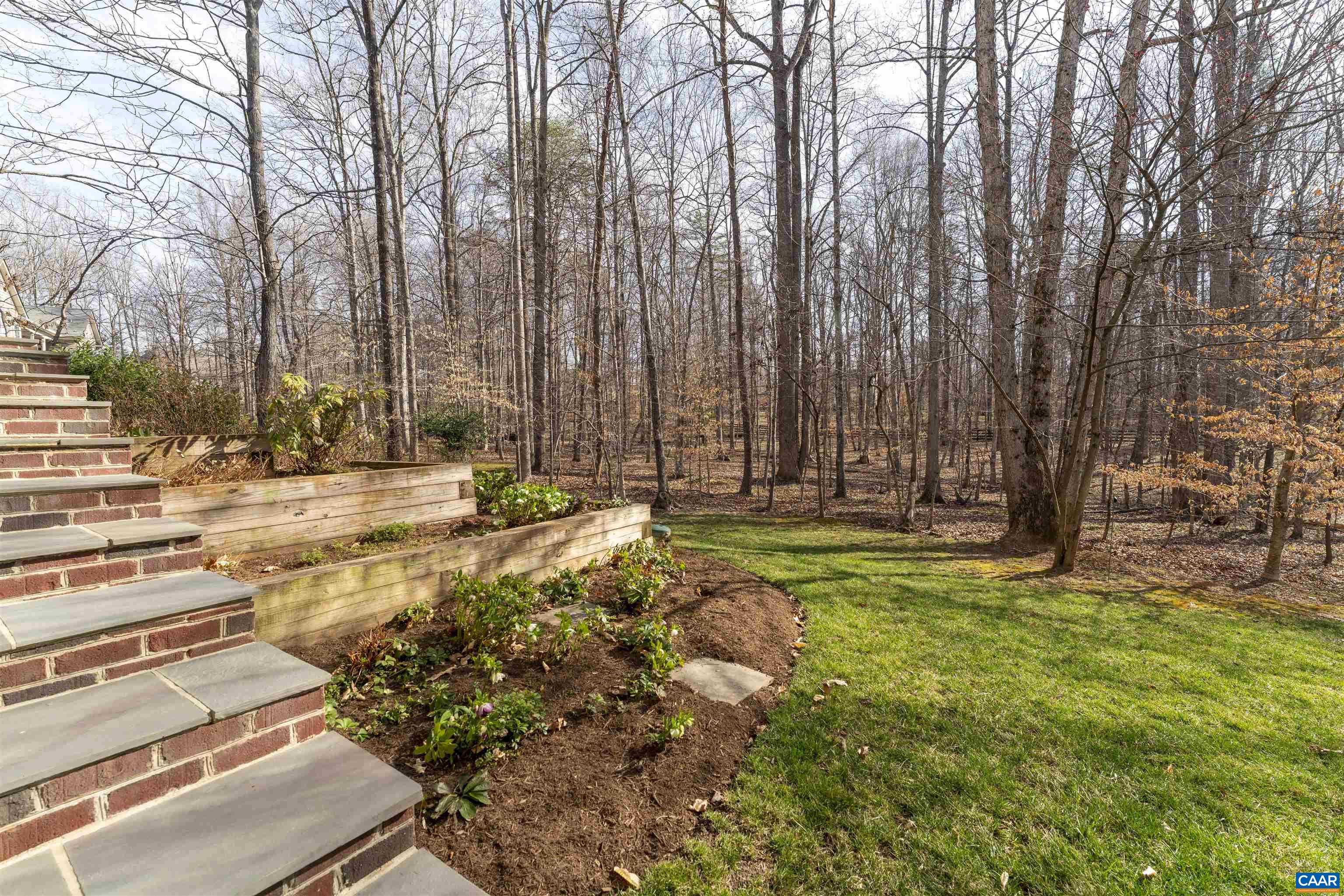 Beautiful staircase along terraced garden beds that lead from the backyard up to the driveway.