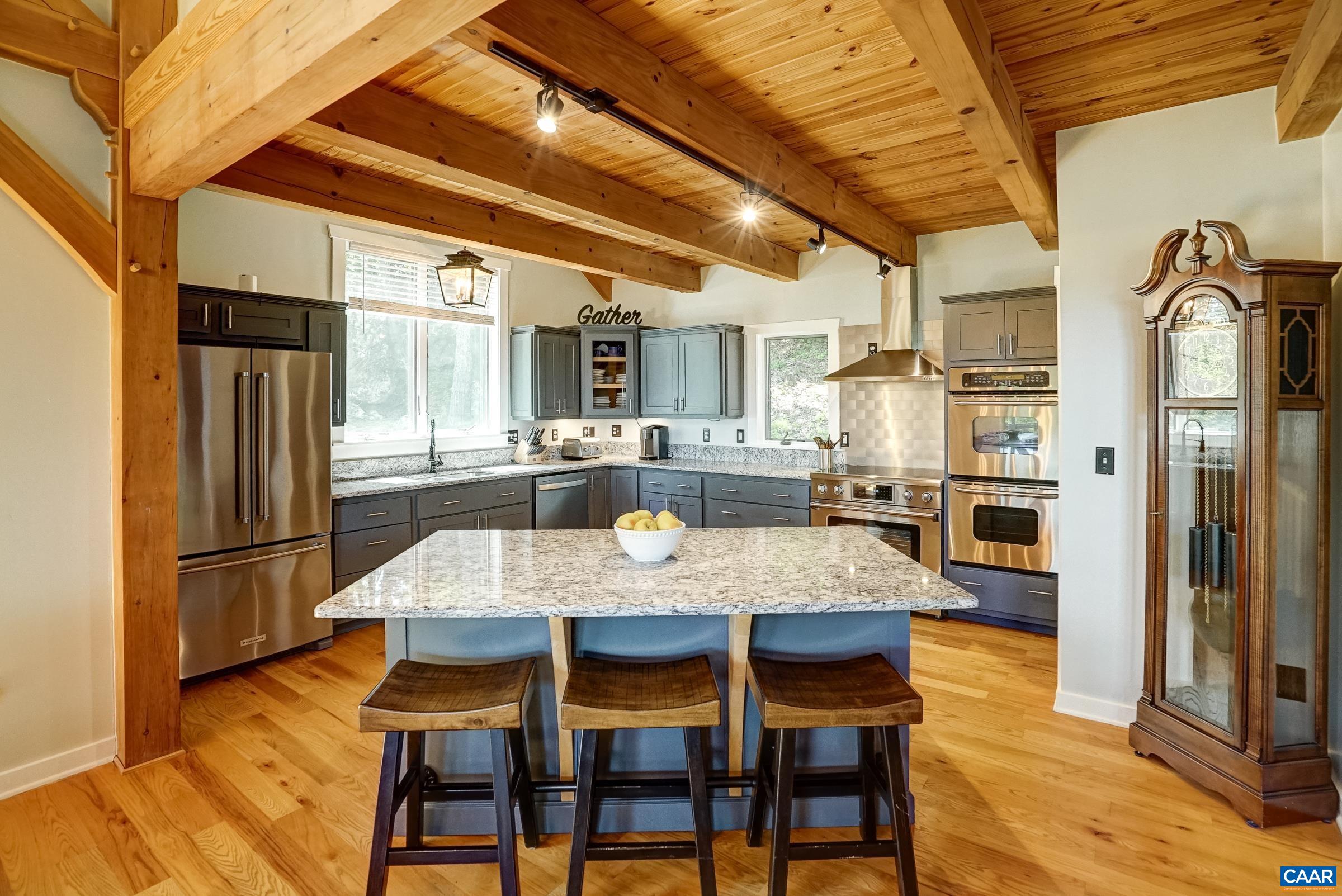 Gourmet kitchen features granite countertops, painted cabinets, and high-end stainless steel appliances.