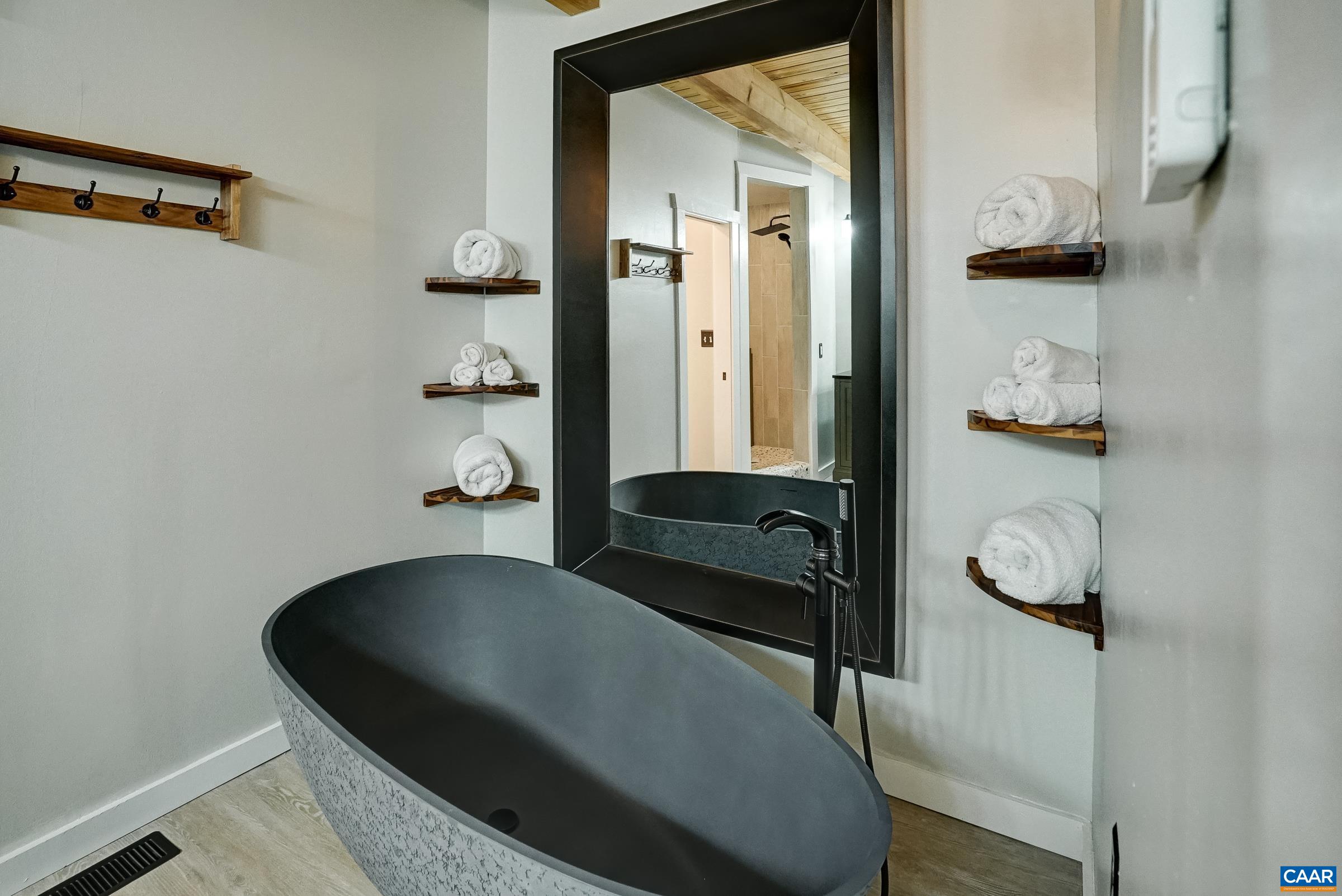 Freestanding soaking tub in the primary suite.