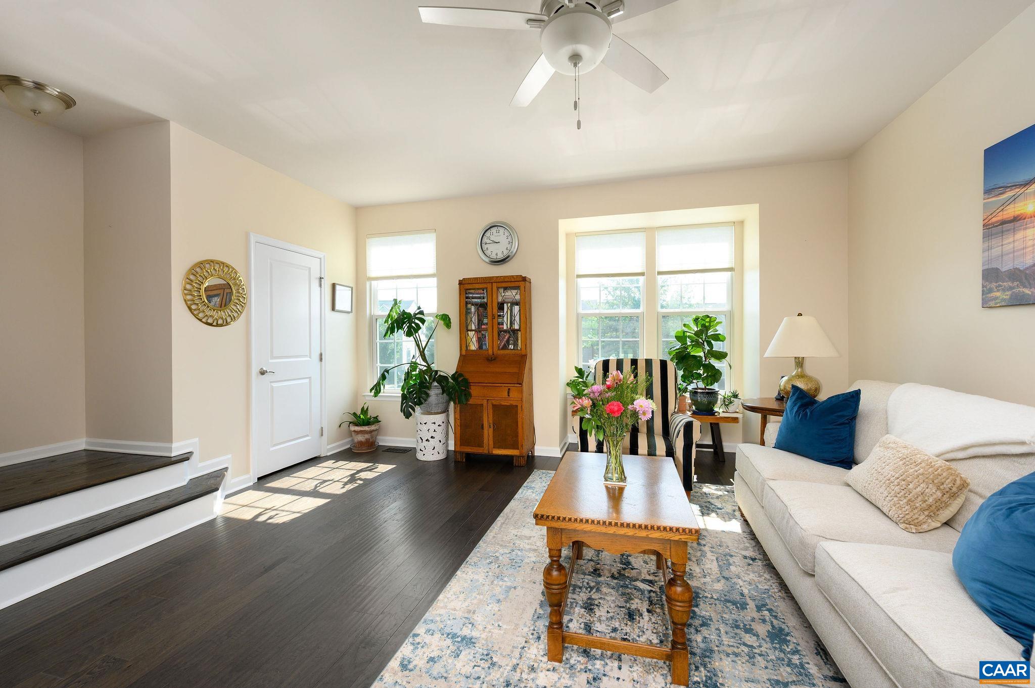 Sunny living room off the kitchen that features a bump out bay window, as well as a second powder room.