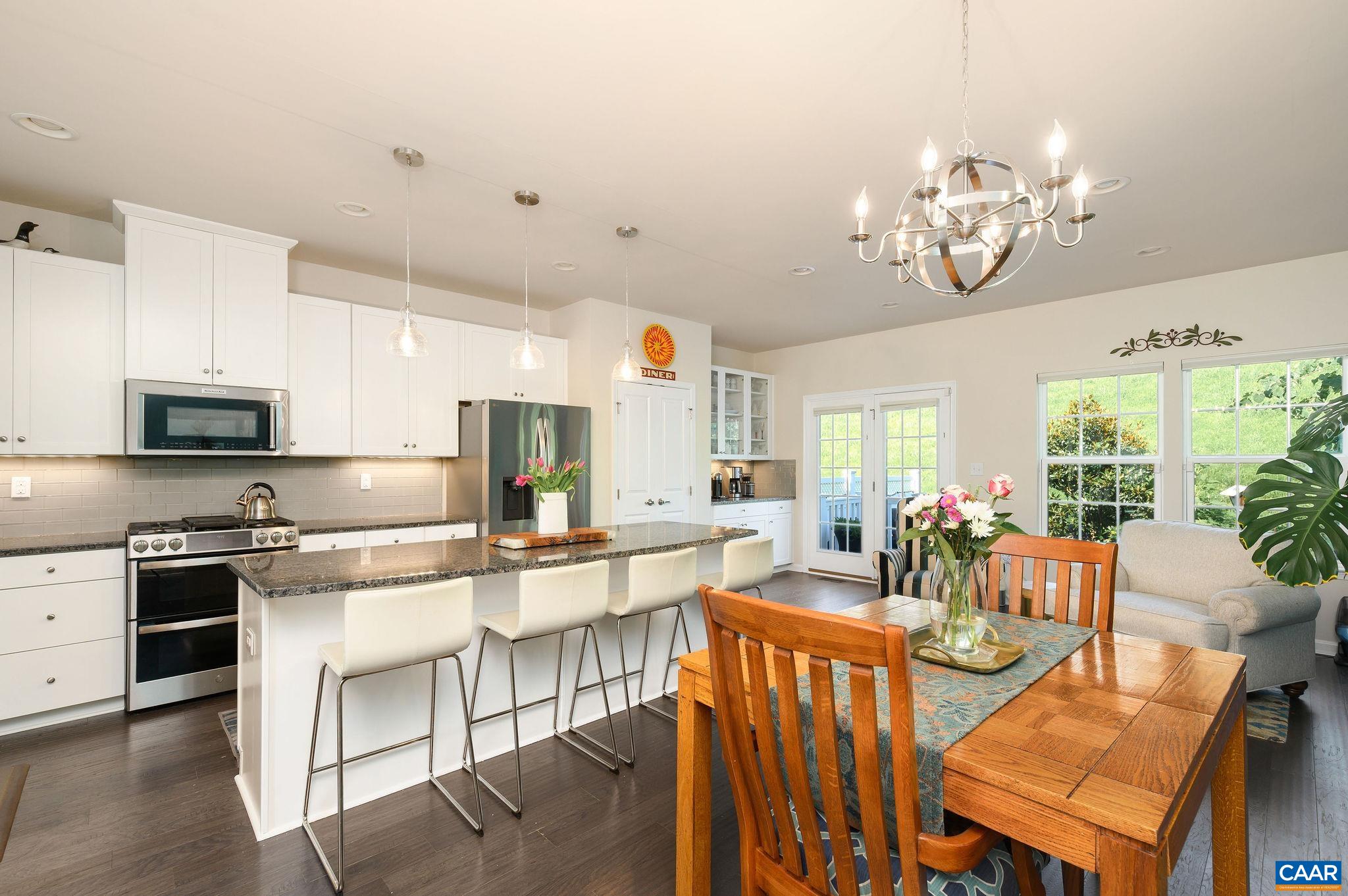 Gourmet kitchen with granite countertops, all new appliances, huge island, hardwood floors, and a spacious pantry.