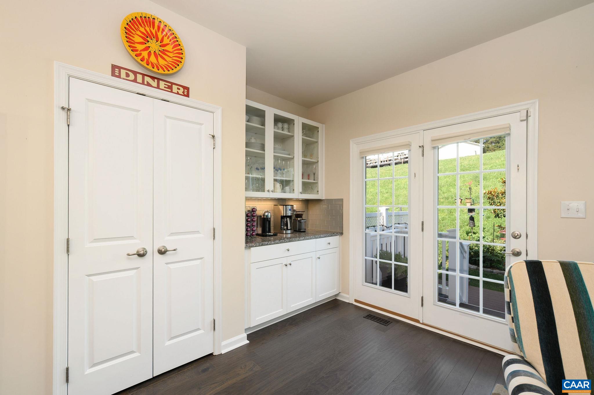 This home was extended during construction and features a wonderful coffee bar with loads of additional cabinet storage, as well as a large sitting area.