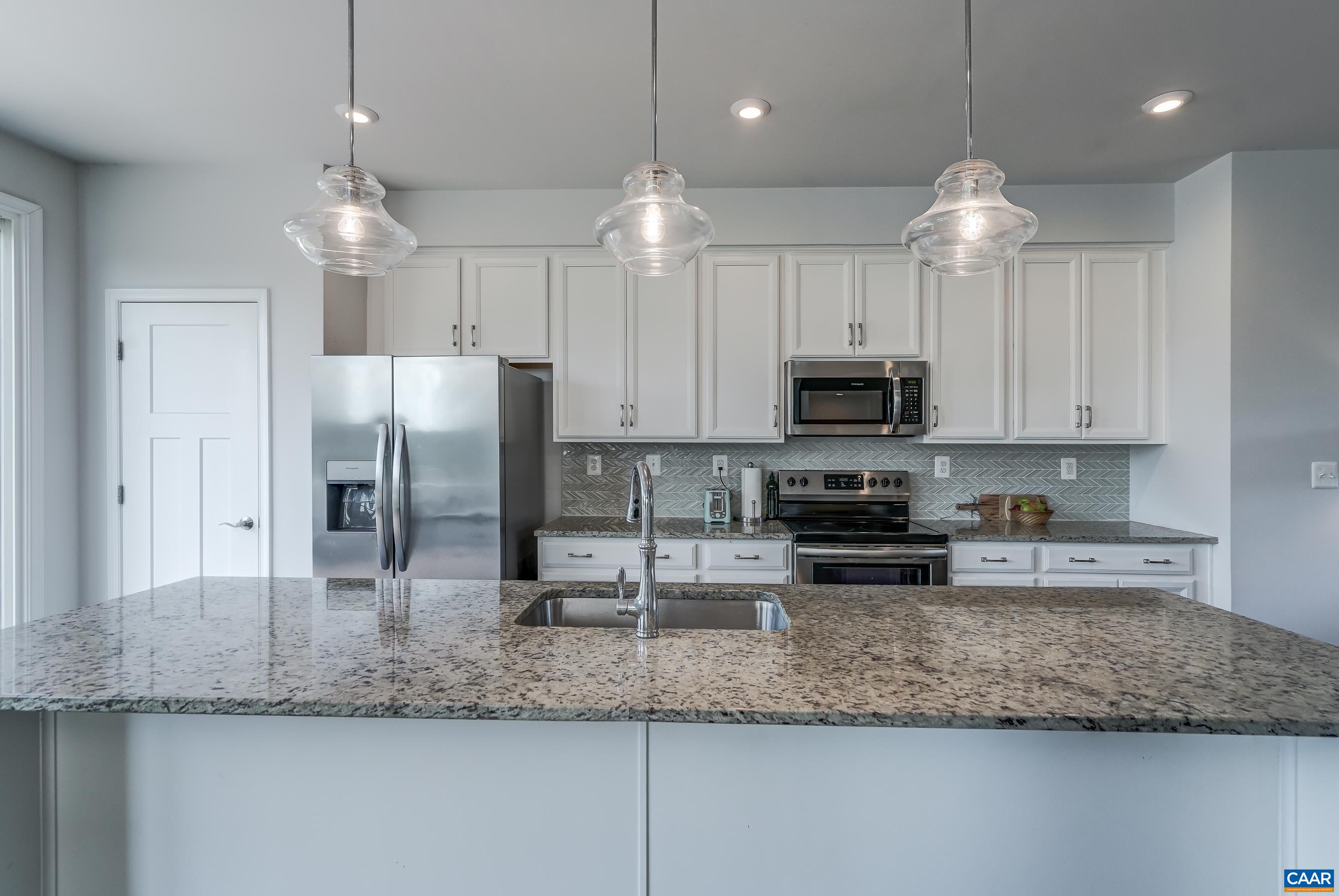 Stainless steel appliances include a new refrigerator.