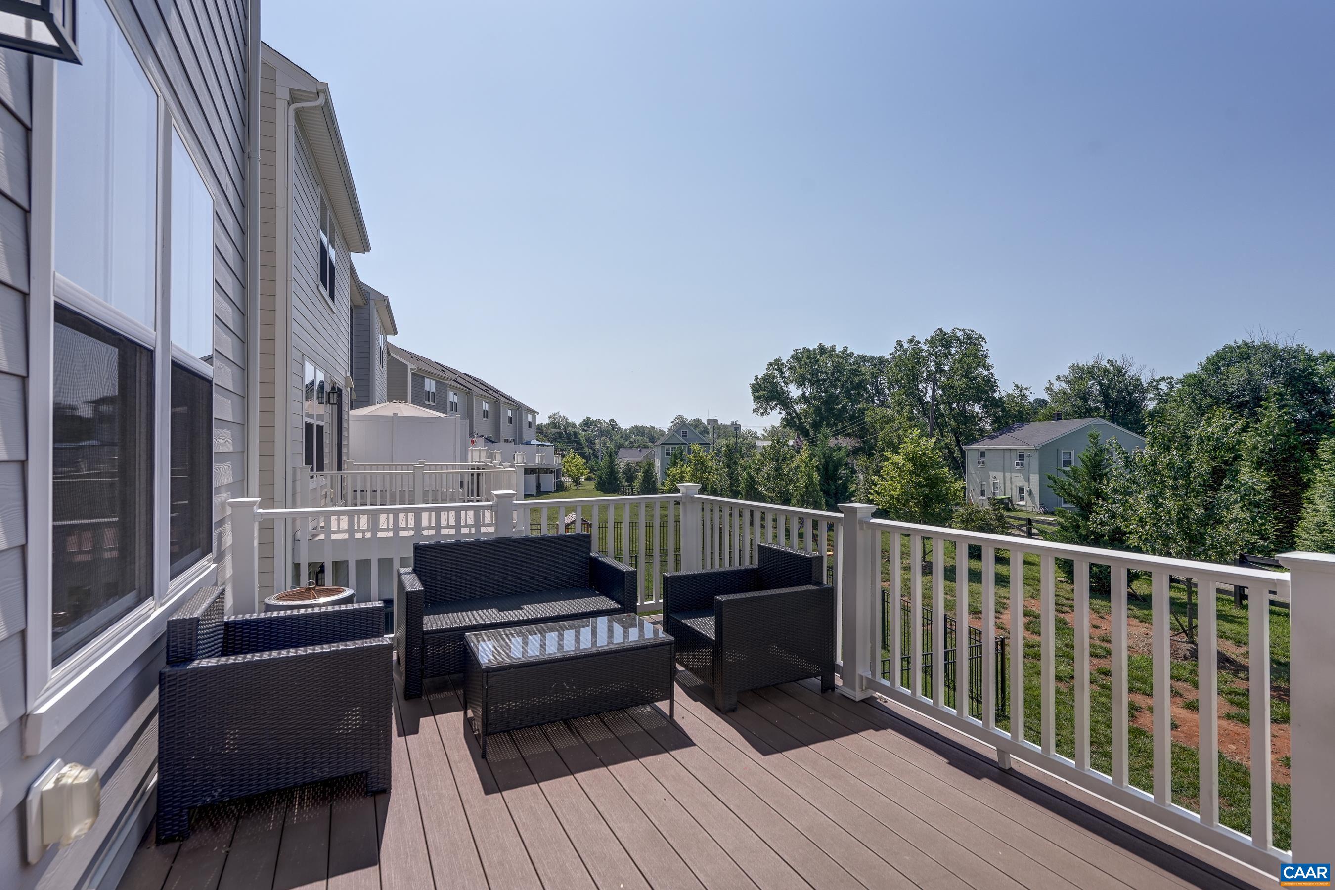 Composite wood deck overlooks quiet back yard.