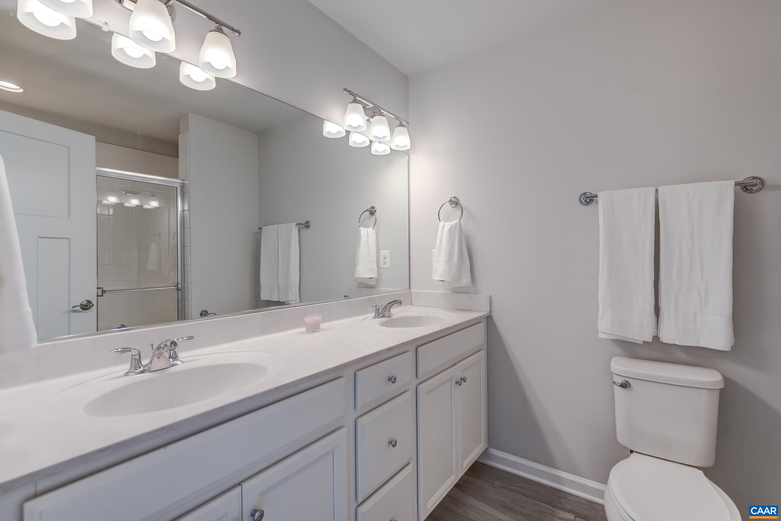Owners bathroom with double sink vanity and shower.