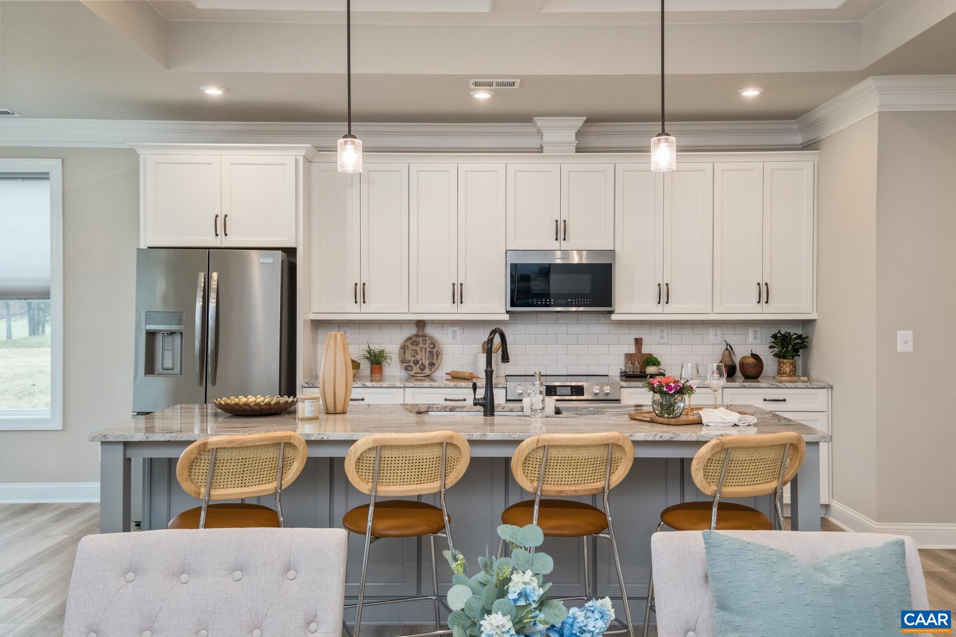 Kitchen features beautiful cabinetry, upgraded granite counterops, upgraded refrigerator and smudge proof stainless steel appliances, and a large island.
