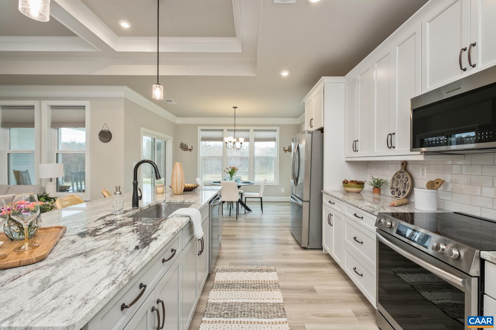 The raised tray and coffered ceiling continues into the kitchen to just over the island.  The kitchen features plenty of space to move and work!