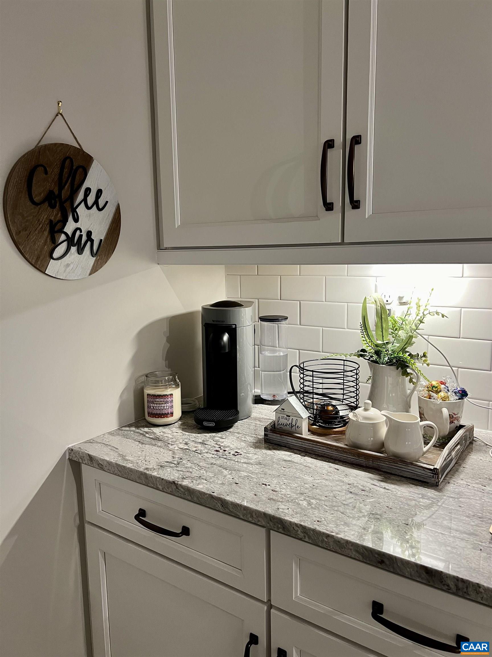 The coffee bar includes upgraded granite, an additional outlet for convenience and use, and upgraded backsplash.