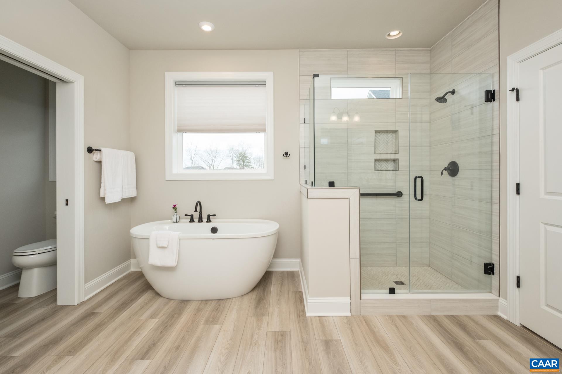 The bathroom features an upgraded tile shower and upgraded faucets on the garden tub.