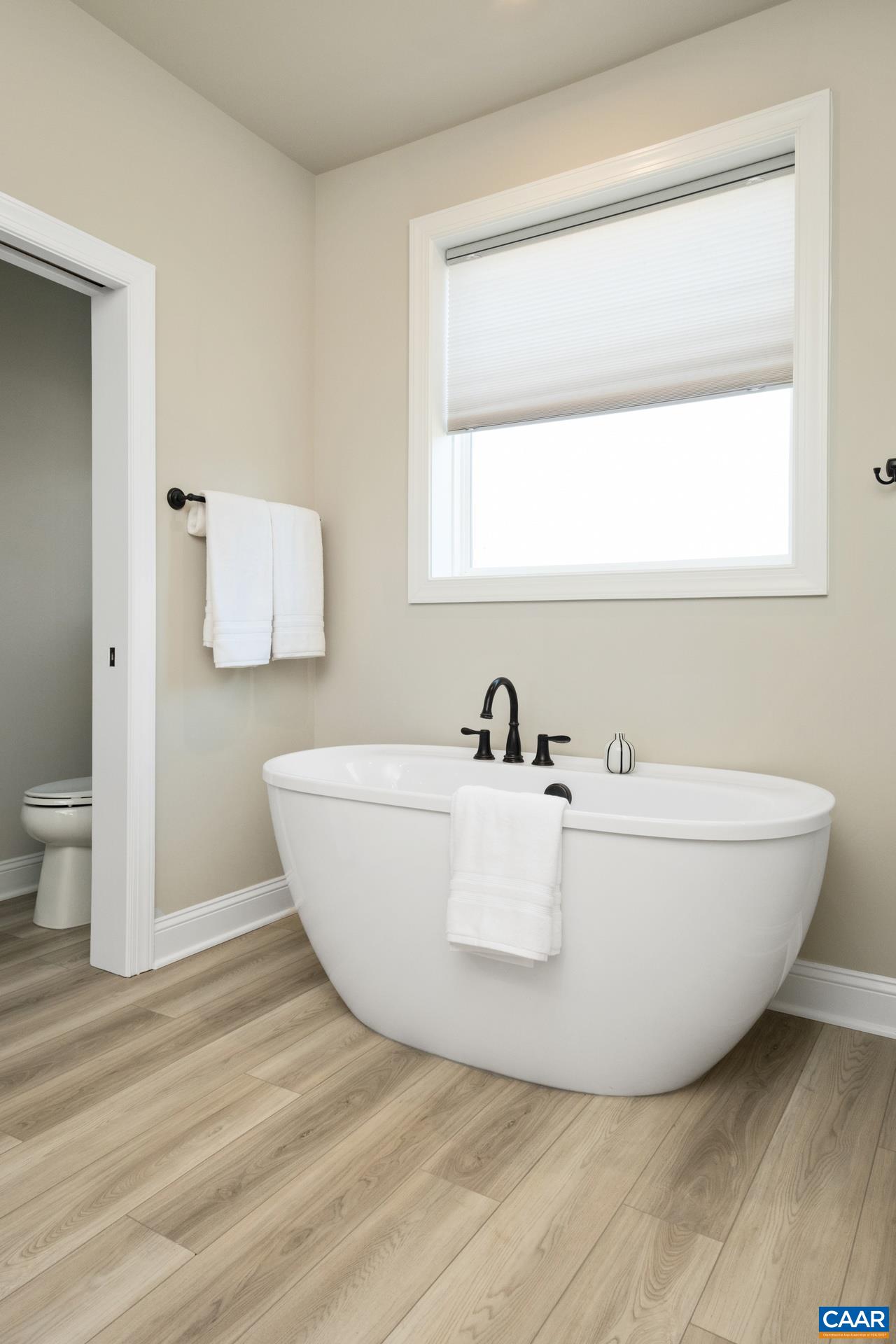 The freestanding garden tub features upgraded faucets.