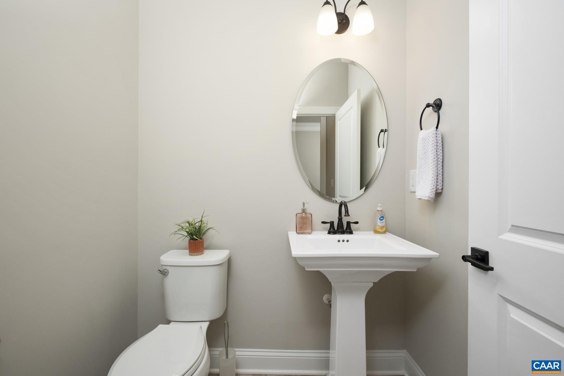The half bath features an upgraded pedestal sink.