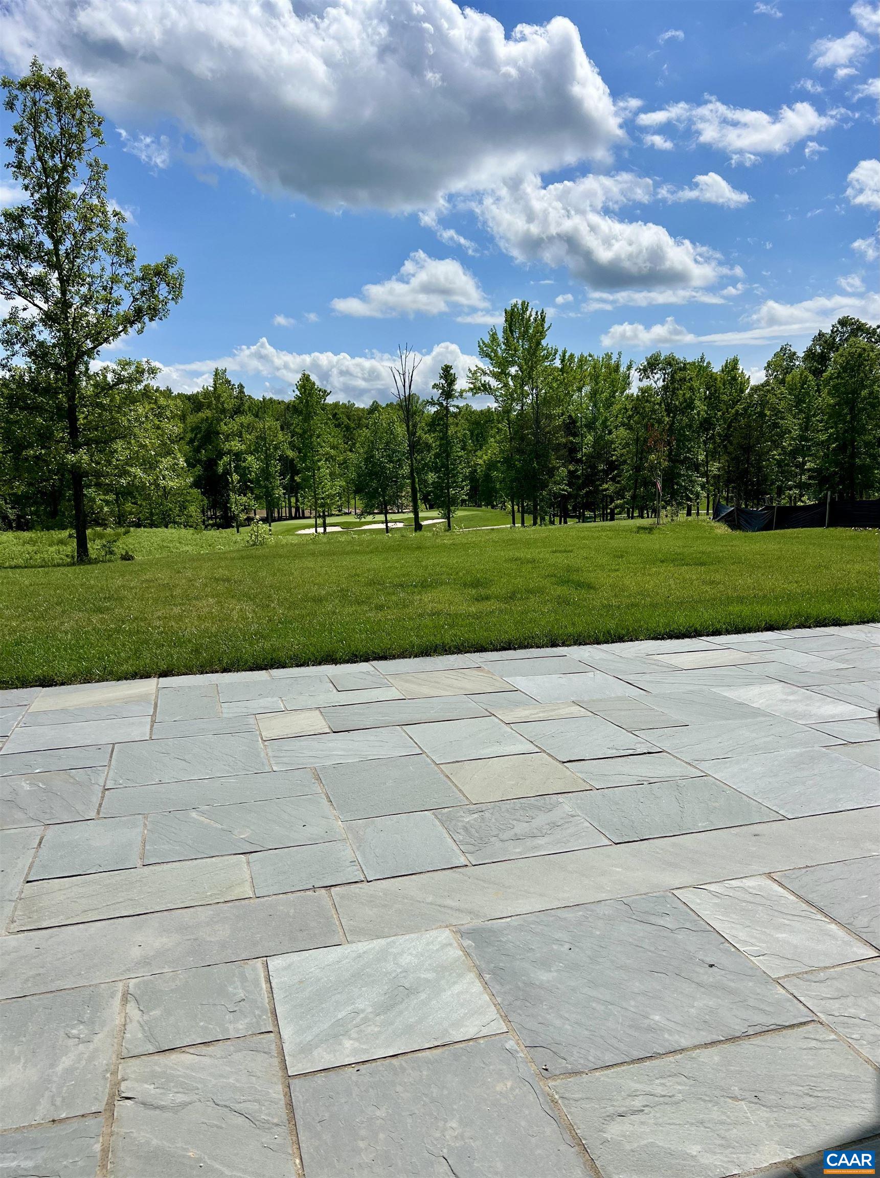 Blue skies and beautiful views of the golf course are just beyond this custom thermal bluestone patio/