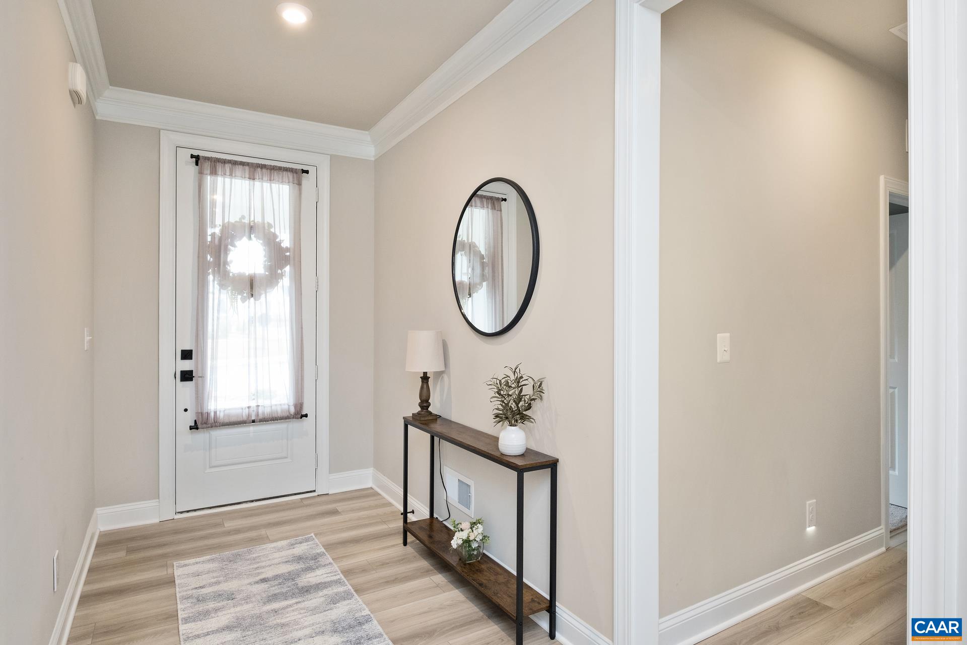 Elegant crown molding greets you in the entry way. The home also features upgraded Luxury Vinyl Plank throughout the main living space.