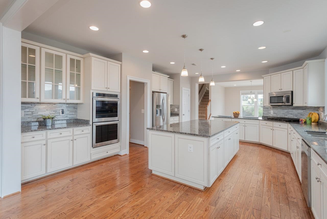 Stainless steel appliances, incredible cabinet space, plus lots and lots of granite countertop space help to make this a wonderful central part of this home