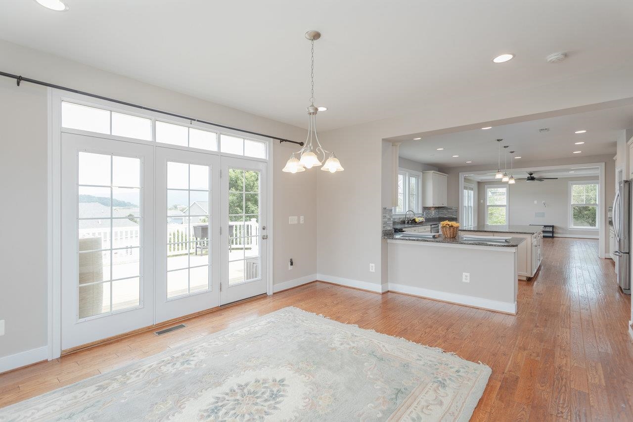 This is a room that is bathed in sunlight and it opens out to the expansive rear deck