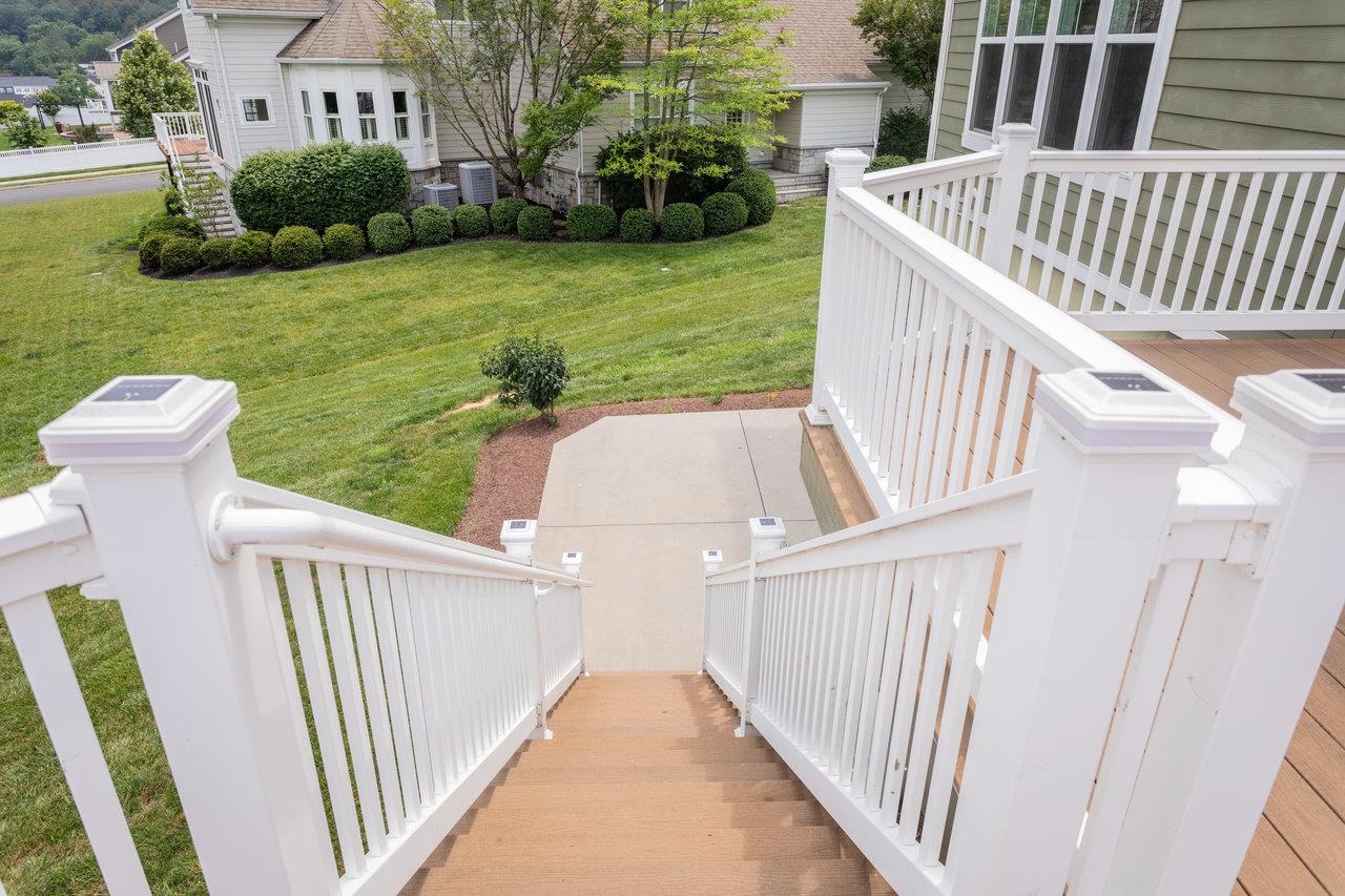 This leads down to the lower level patio and a yard that includes a tool shed and garden space