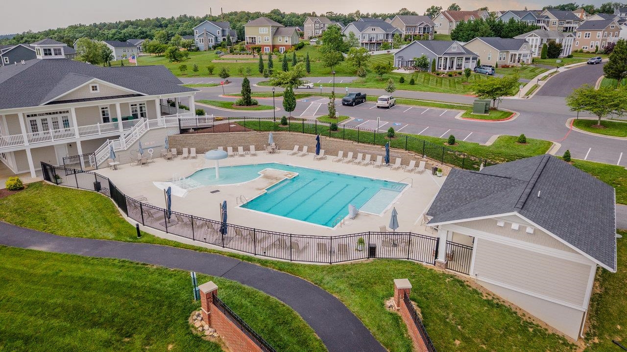 The pool adjoins the Community Center which offers an exercise room, kitchen, community gathering room and covered porch overlooking the lake