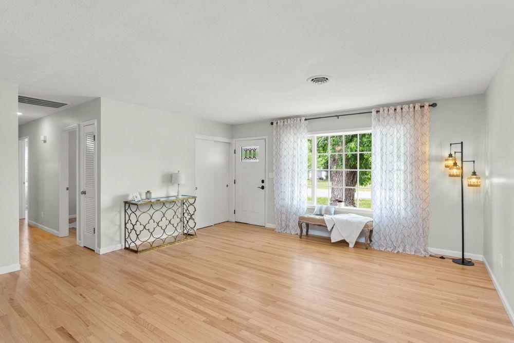 looking from dining area with hall to 3 bedrooms and full bath w/ laundry