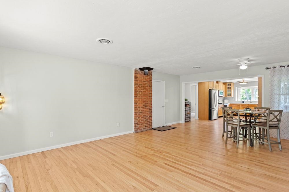 entrance into the living room and open floor plan with owner's suite and garage entrance to the left before the kitchen.