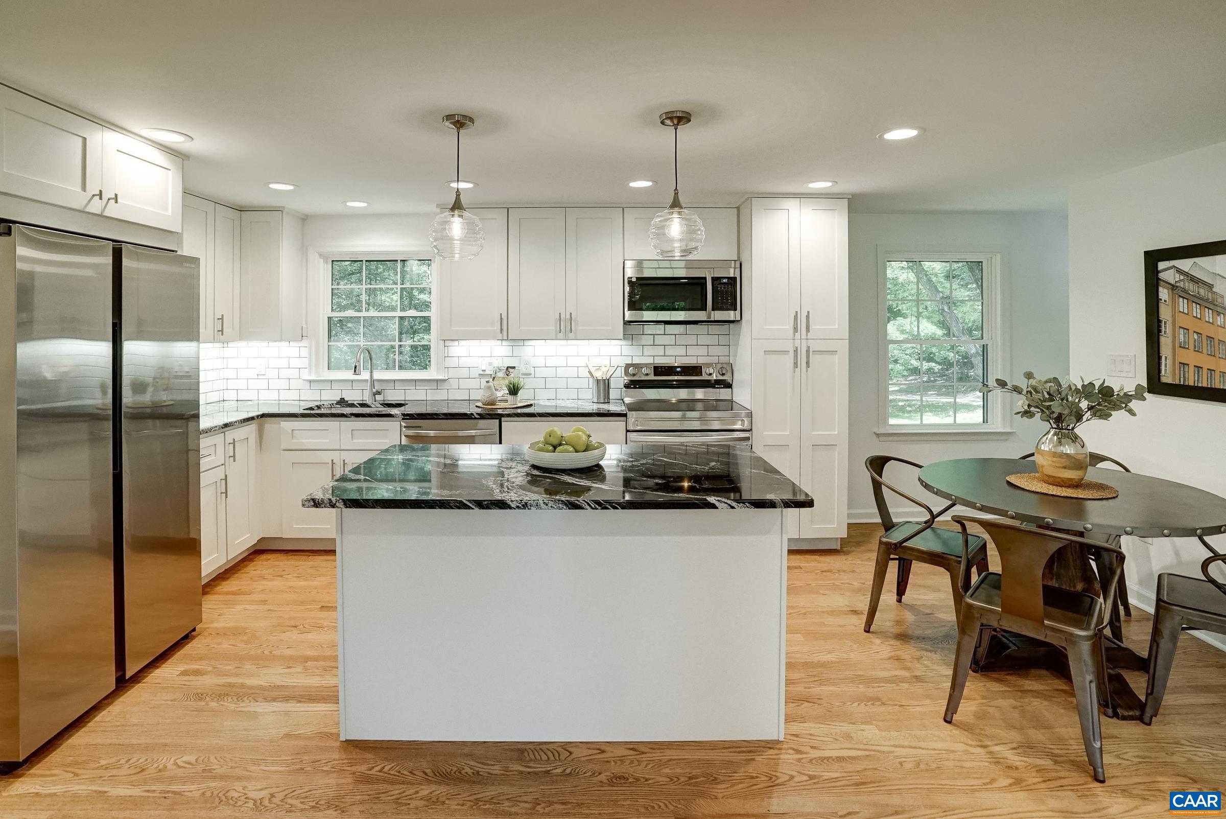 All new kitchen with white cabinets, granite counters, and new stainless steel appliances.