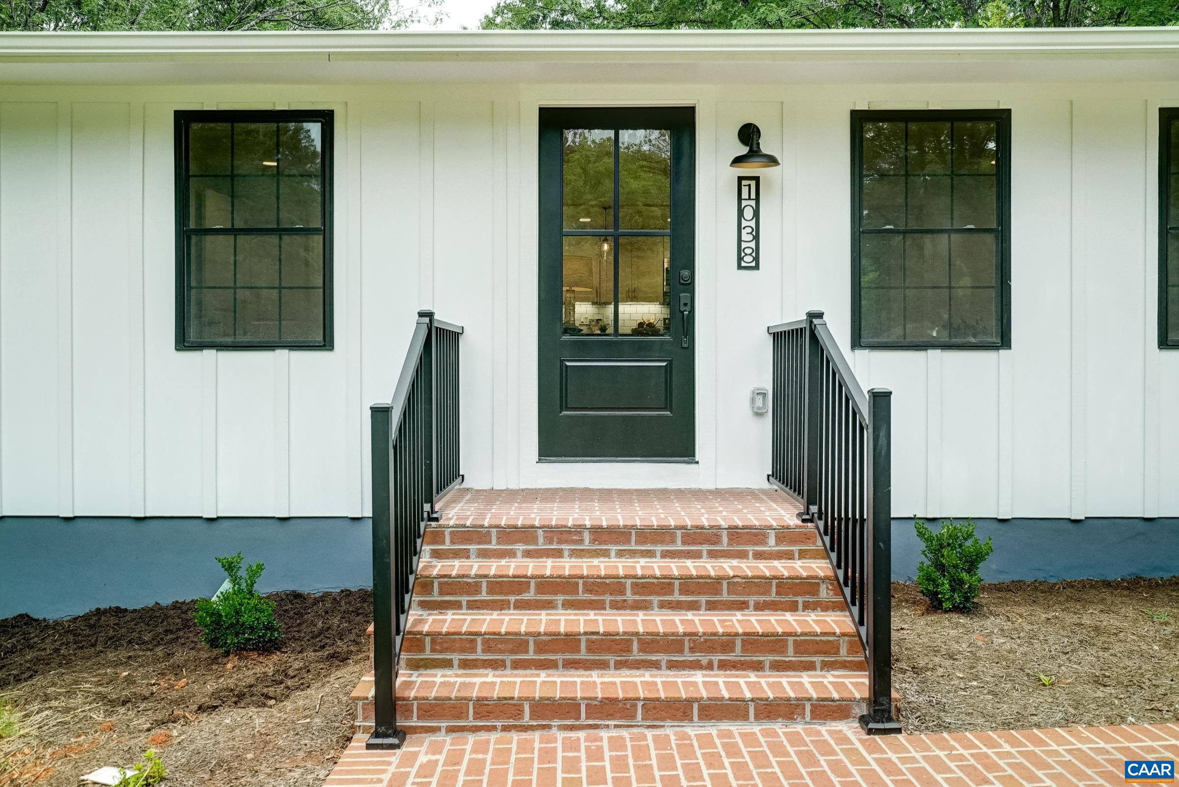 Welcoming brick front steps with low maintenance powder coated aluminum railings.