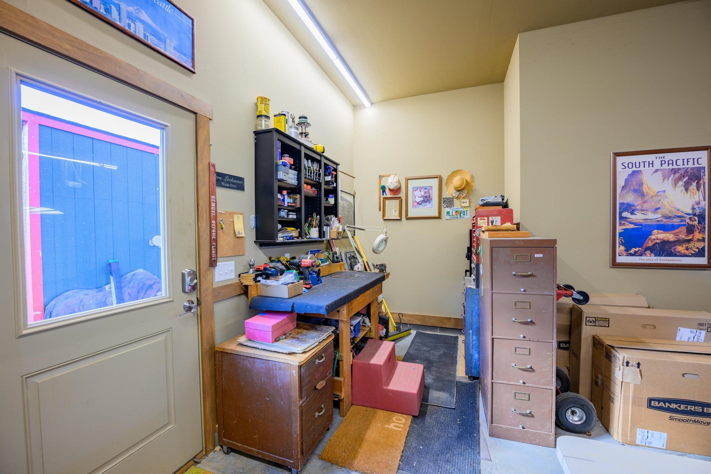 Work space in the garage, with a door to the exterior.