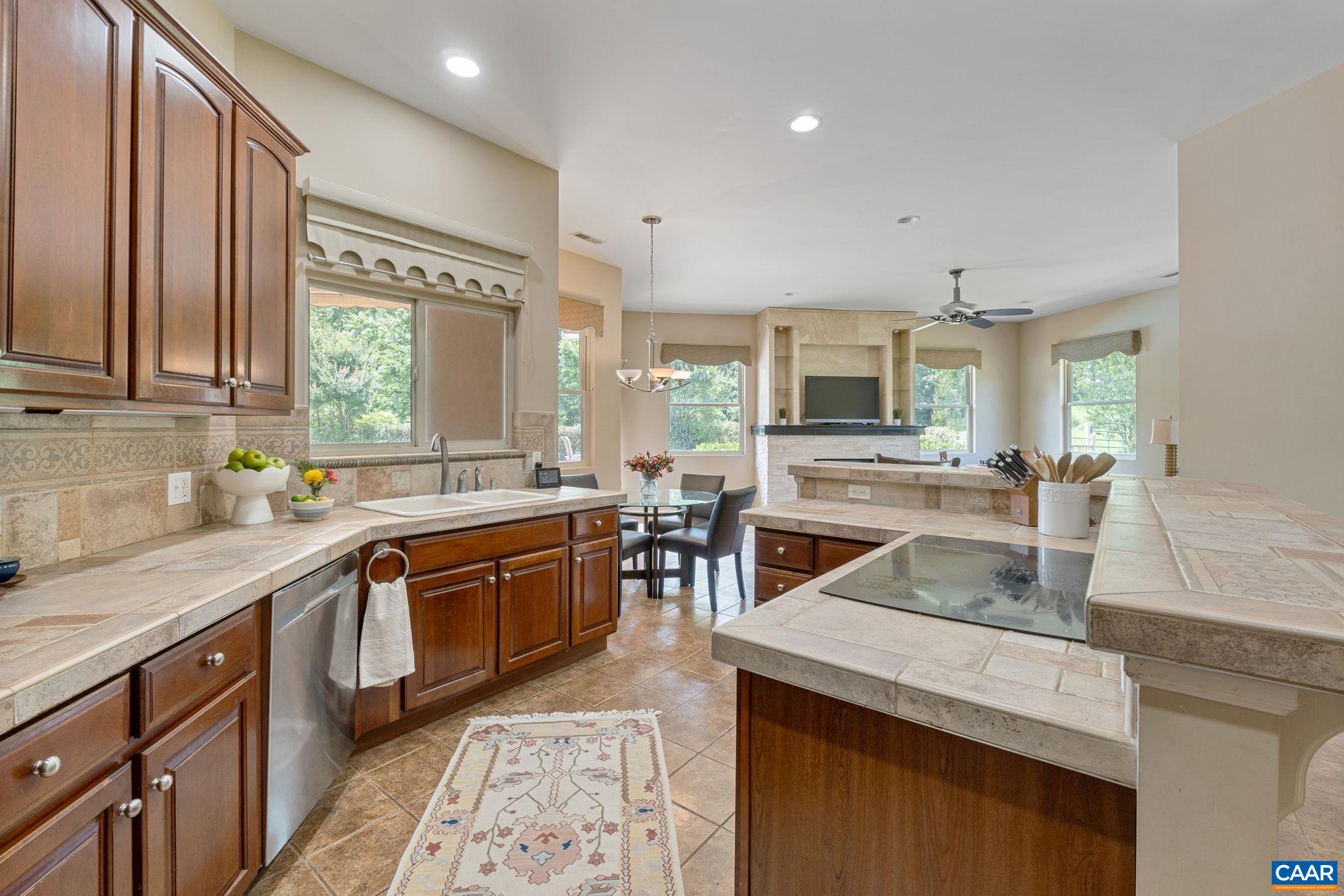 Kitchen features pantry cabinet, wall oven & microwave, bar seating, and most importantly a wonderful view to the outdoor patio and pool!