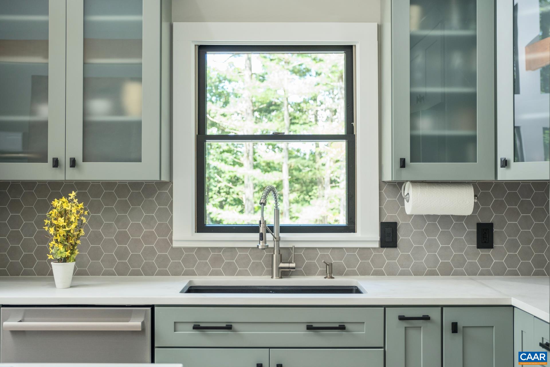 The kitchen sink is quartz and includes a removable custom fit cutting board and drying rack.