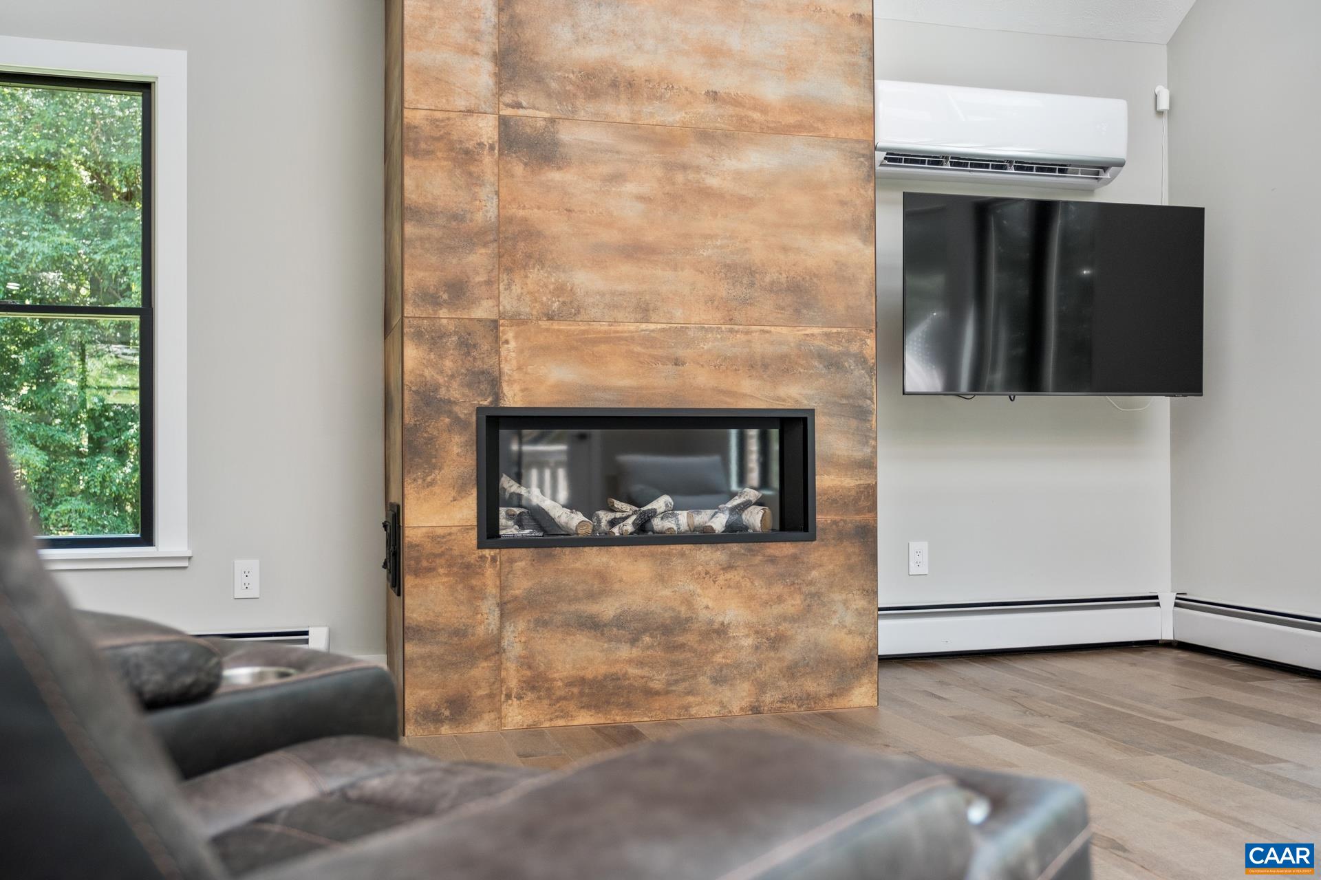 New linear gas fireplace with a floor-to-ceiling tile surround.