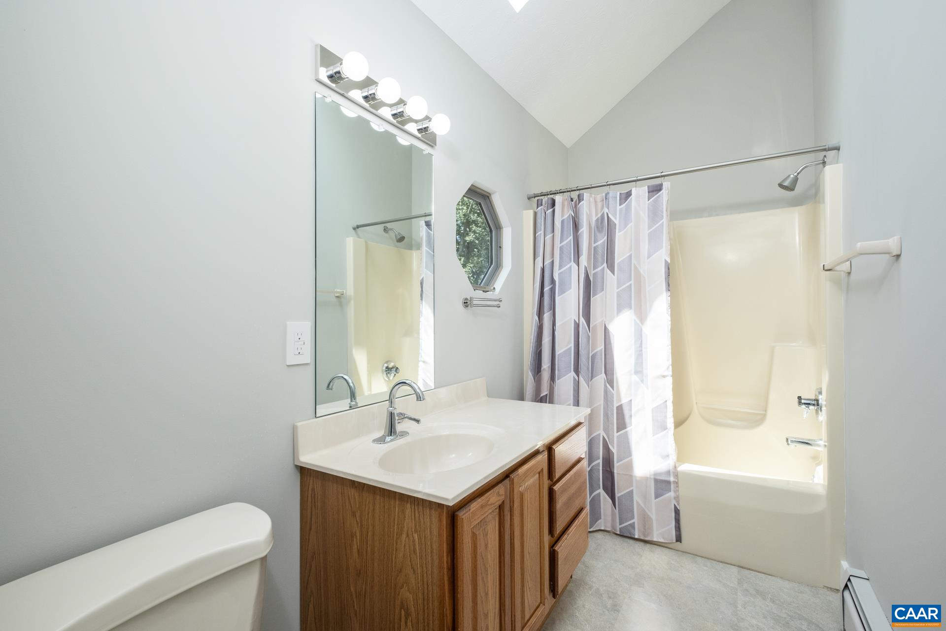 The second level full bathroom features a skylight to let in plenty of sunlight.