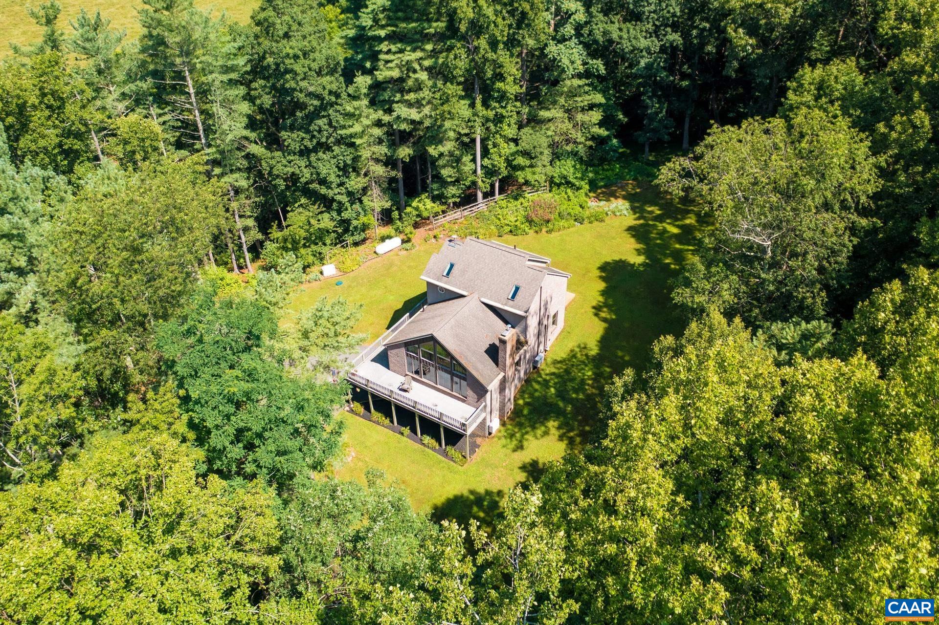 The property sits in a clearing, surrounded by a wooded area for privacy.  About 50 trees were removed to create an open space, while still maintaining privacy from the wooded area.