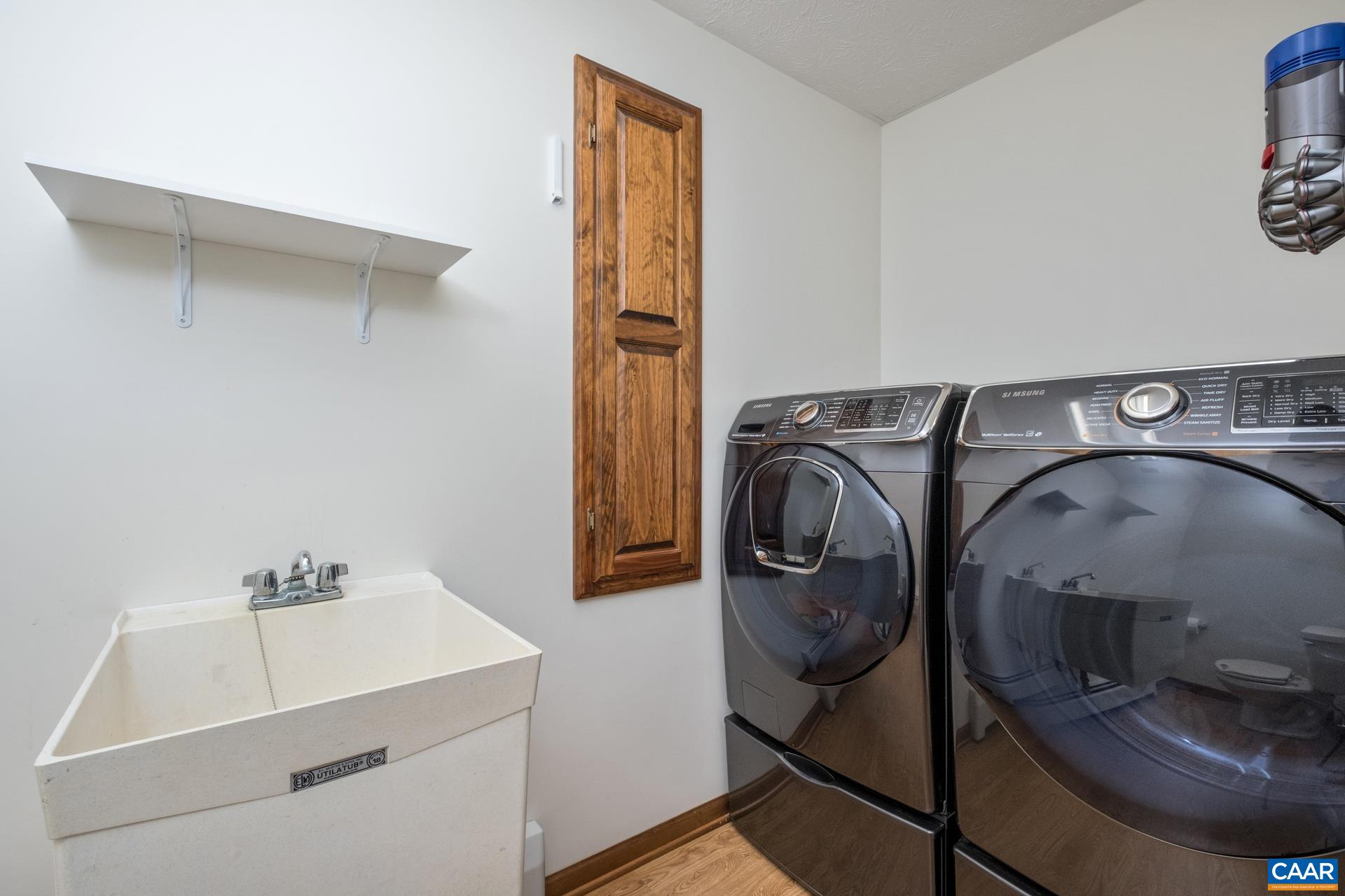 The laundry room is located on the main level and features a laundry sink and half bath.