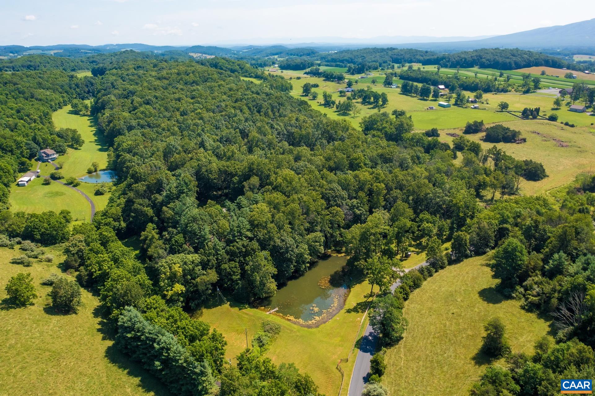 The large pond with a dock is in front of the property. The pond is stocked with bass.