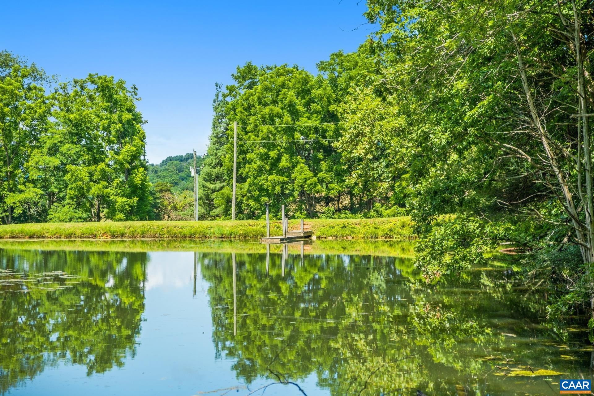 The large pond is located on one side of the driveway.  A smaller pond is on the other side of the driveway.  The pond is stocked with bass.