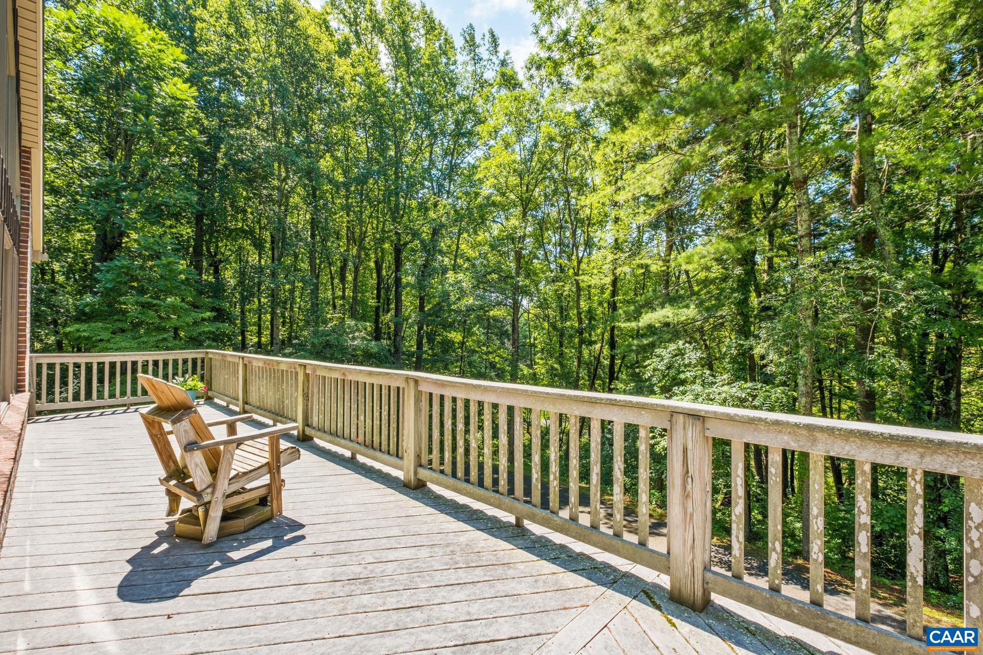 Enjoy the bright sunshine on the front deck that overlooks the pond.